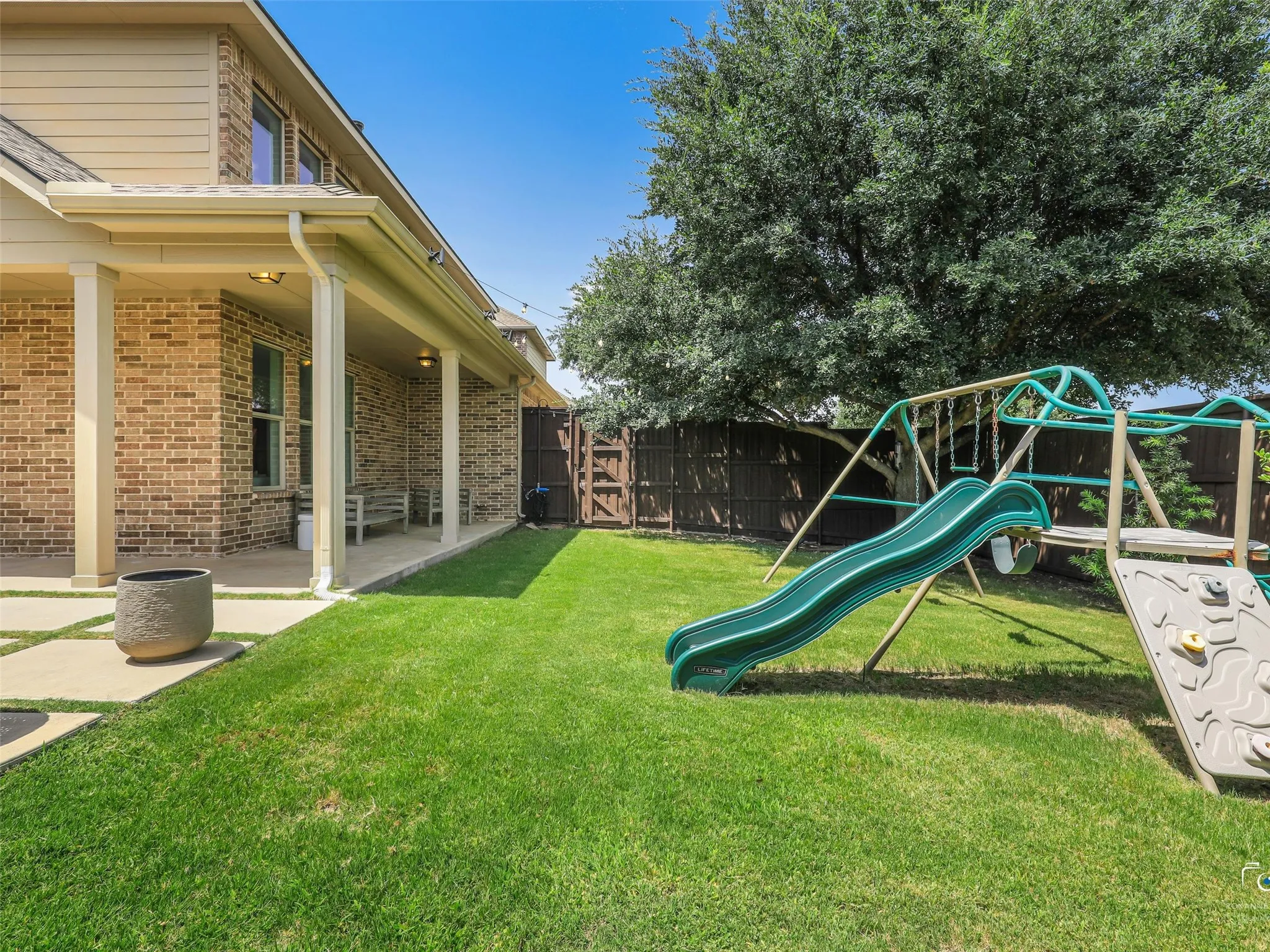 Spacious back yard with beautiful mature trees and plenty of space for running around.