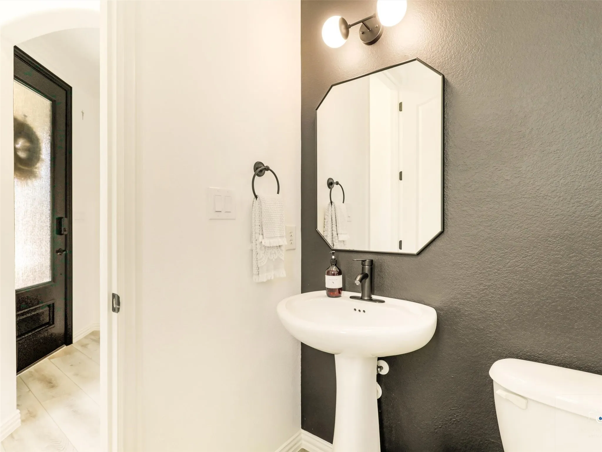 Stylishly updated half bath with modern fixtures and designer finishes.