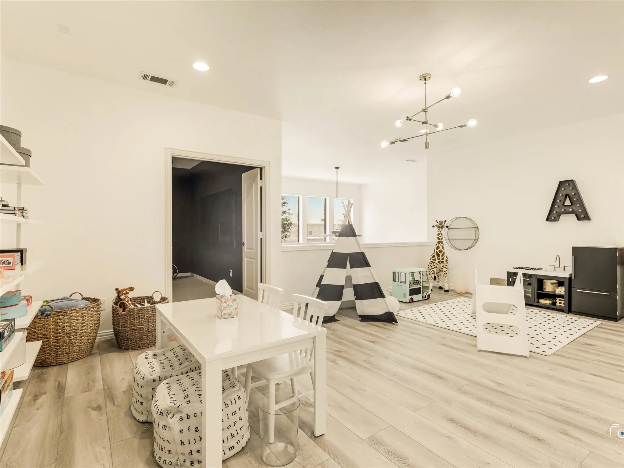 Large flex space provides the perfect setting for entertaining, movie nights, children's play area, or additional family living.