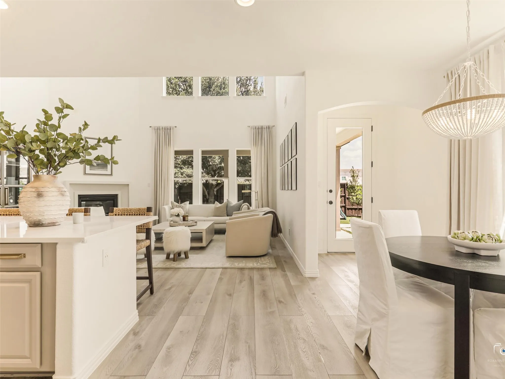Wall of windows fills the spacious living room with natural light while overlooking the private backyard.