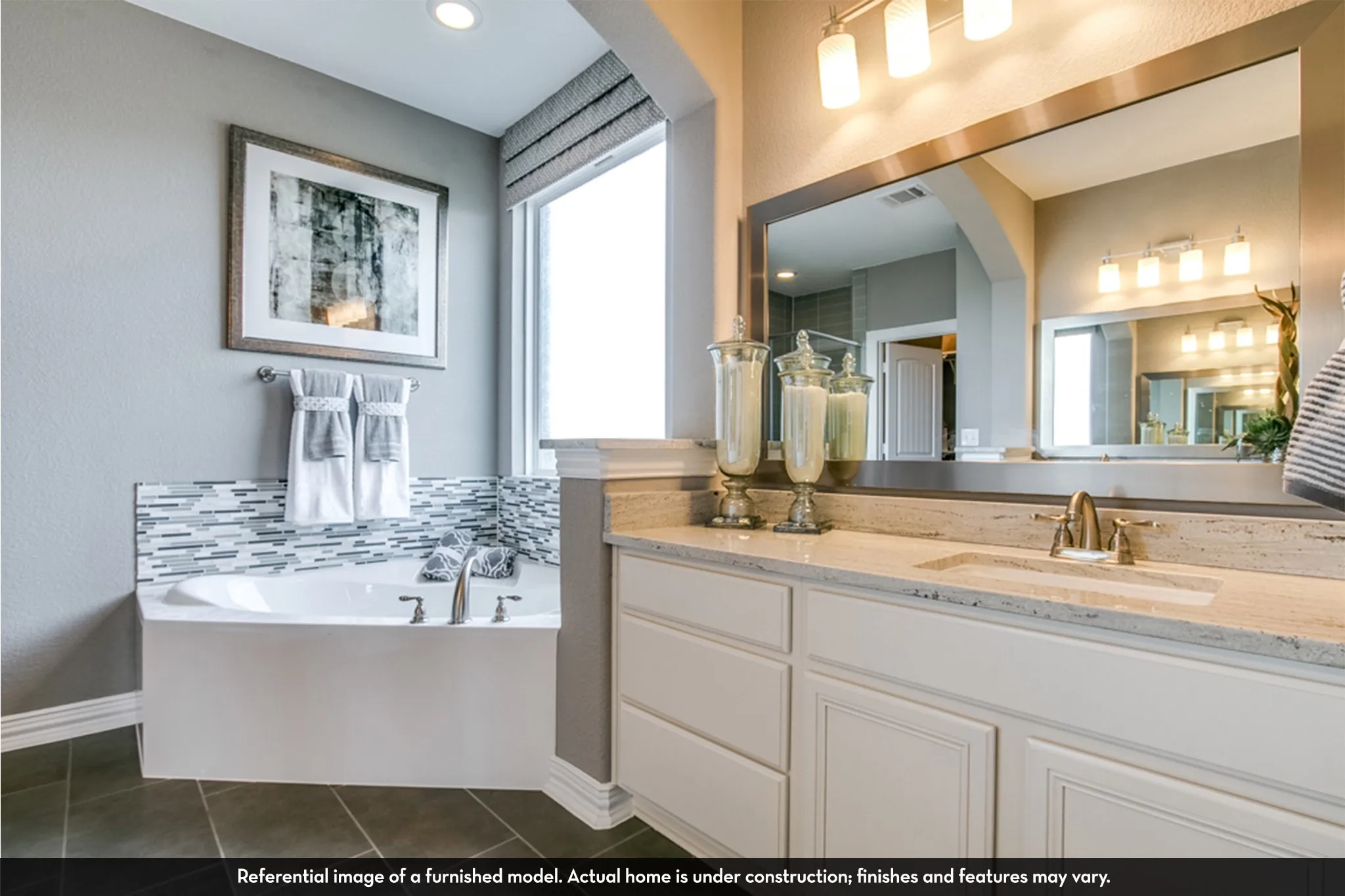 Bathroom vanity featuring a light-toned countertop, undermount sink, and brushed nickel faucet