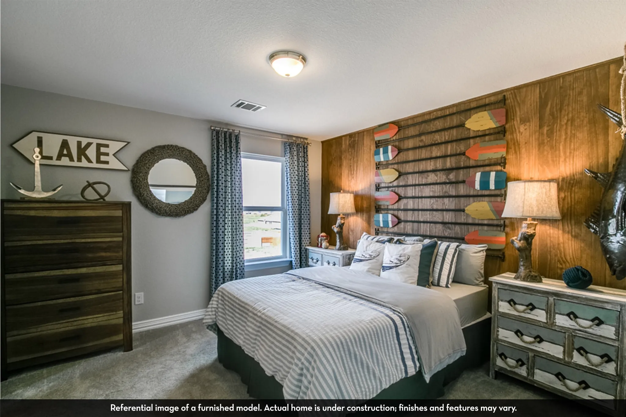 Bedroom featuring a prominent wood-paneled accent wall, neutral wall paint, and gray carpet flooring