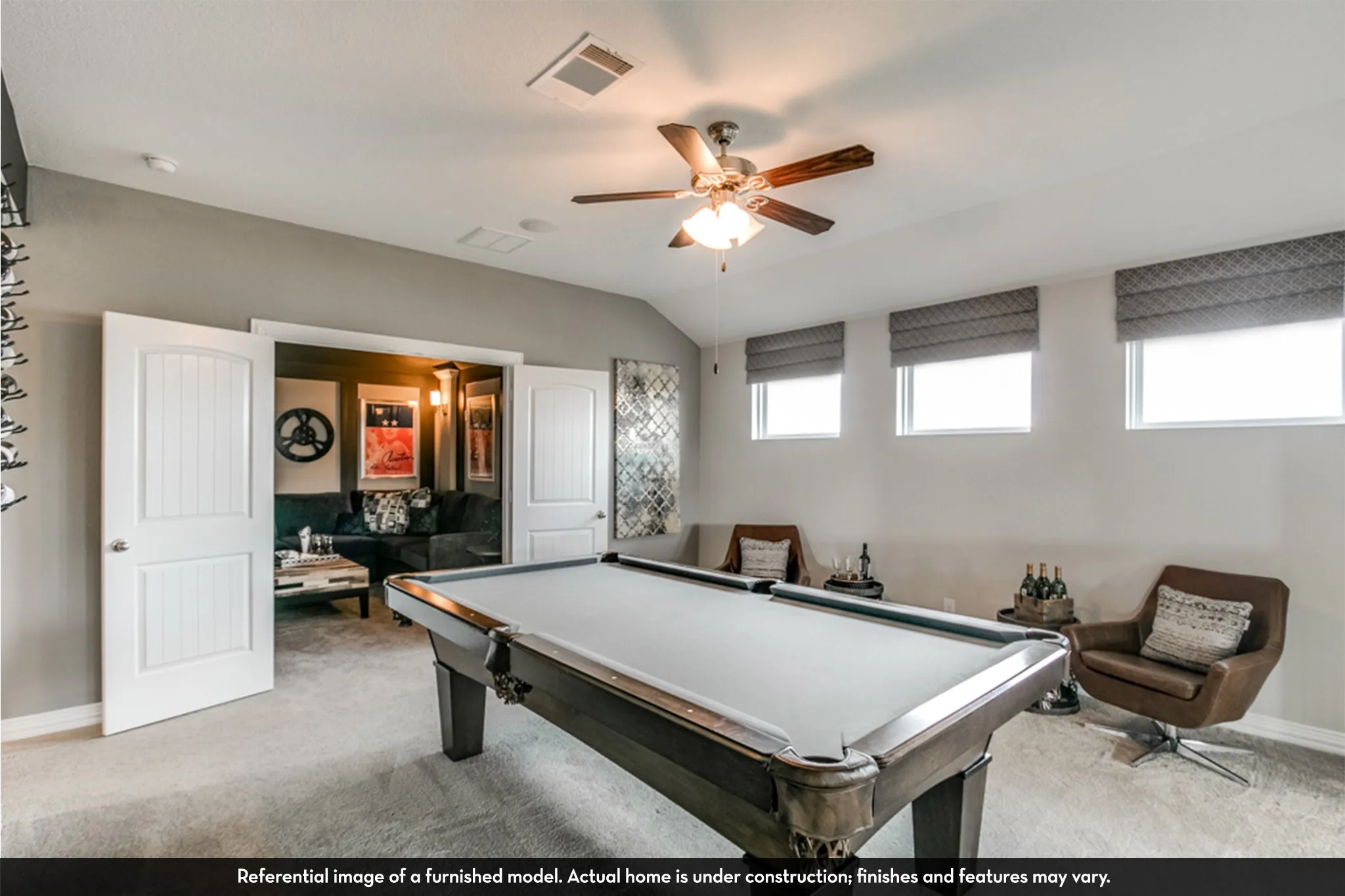 Spacious bonus room featuring carpet flooring and a ceiling fan with light fixture