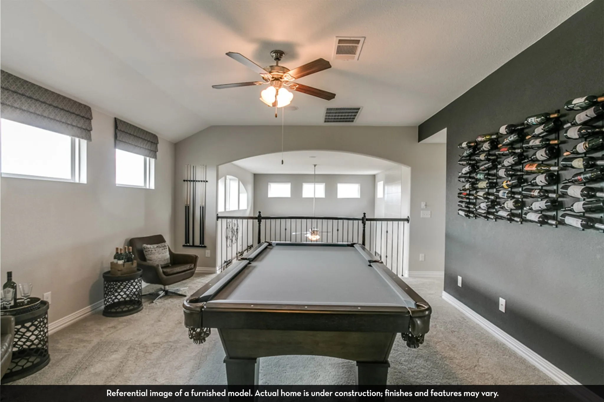 Spacious upstairs bonus room featuring soft carpeting and an arched entryway