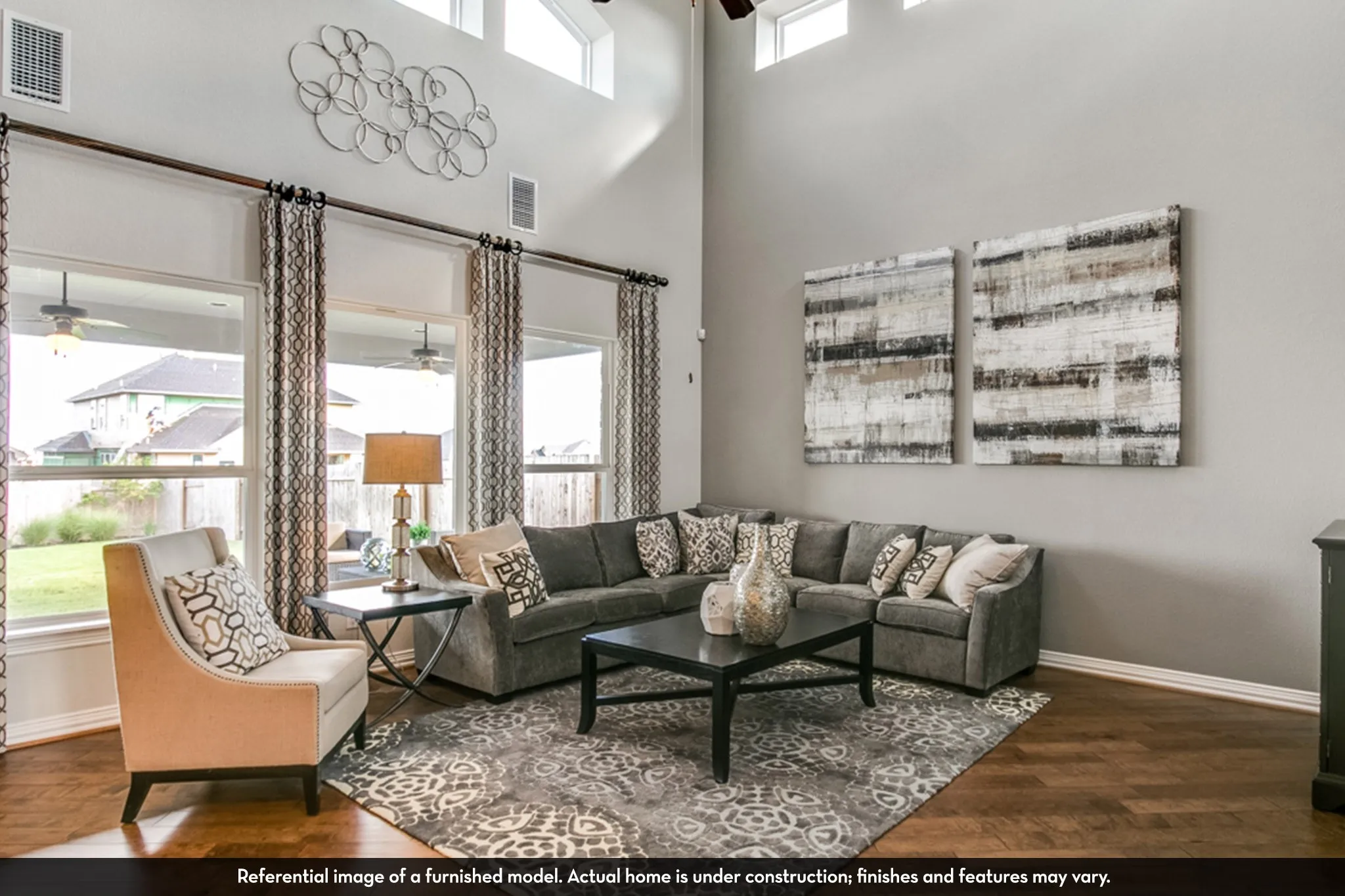 Spacious interior featuring high ceilings, wood-finish flooring, and multiple large windows