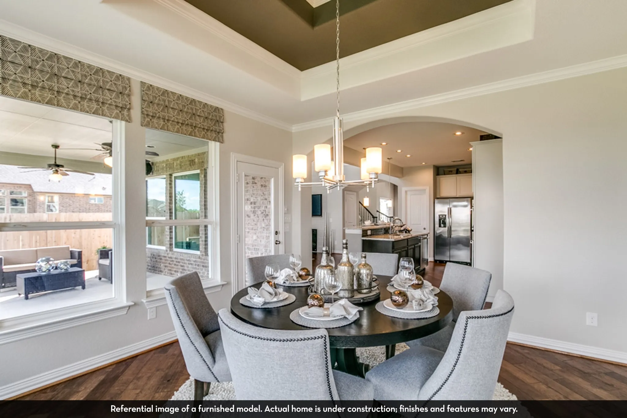 Dining area with coffered ceiling and wood-finish flooring