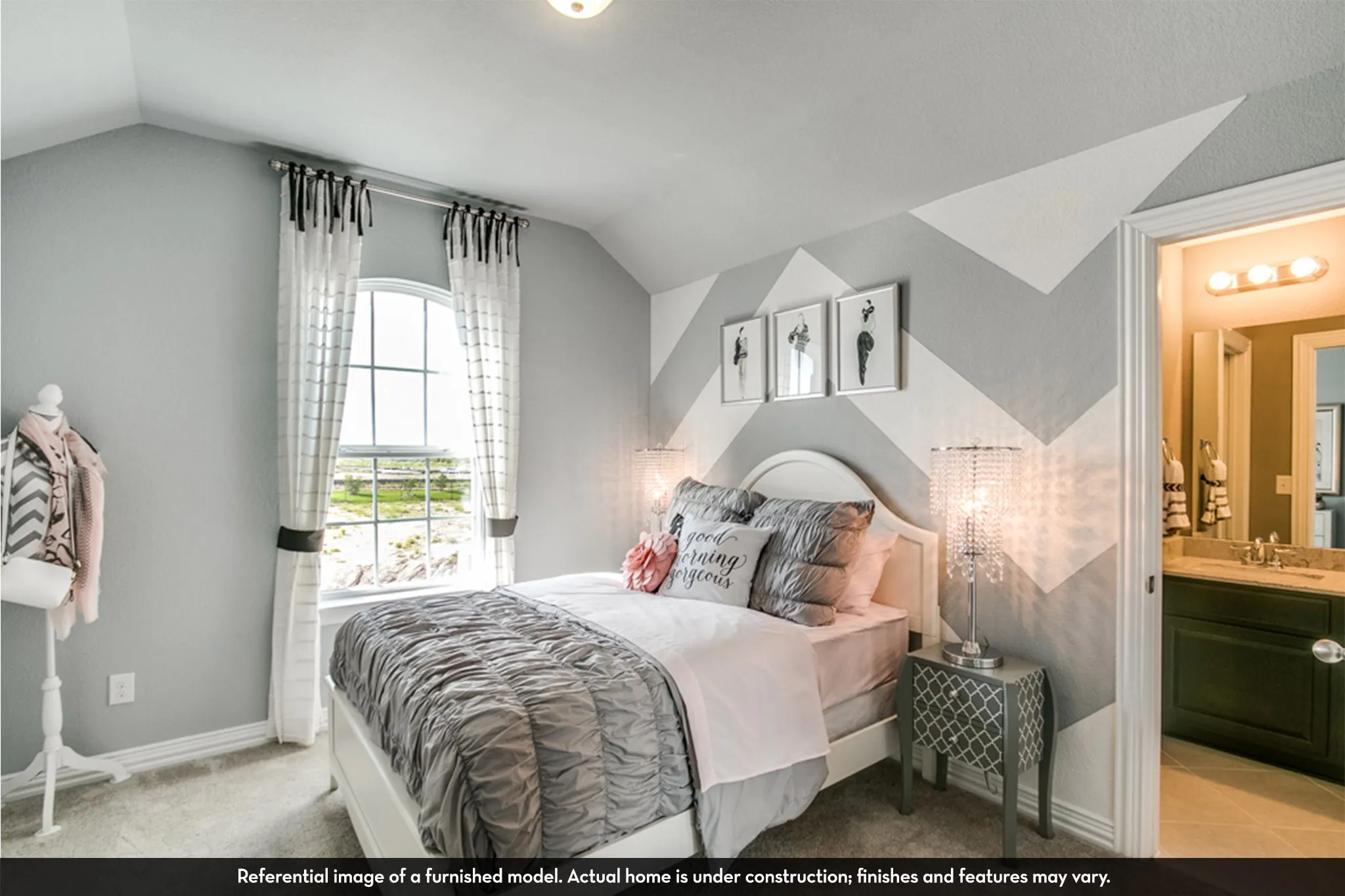 Bedroom featuring an arched window with grid patterns, carpet flooring, and a decorative accent wall