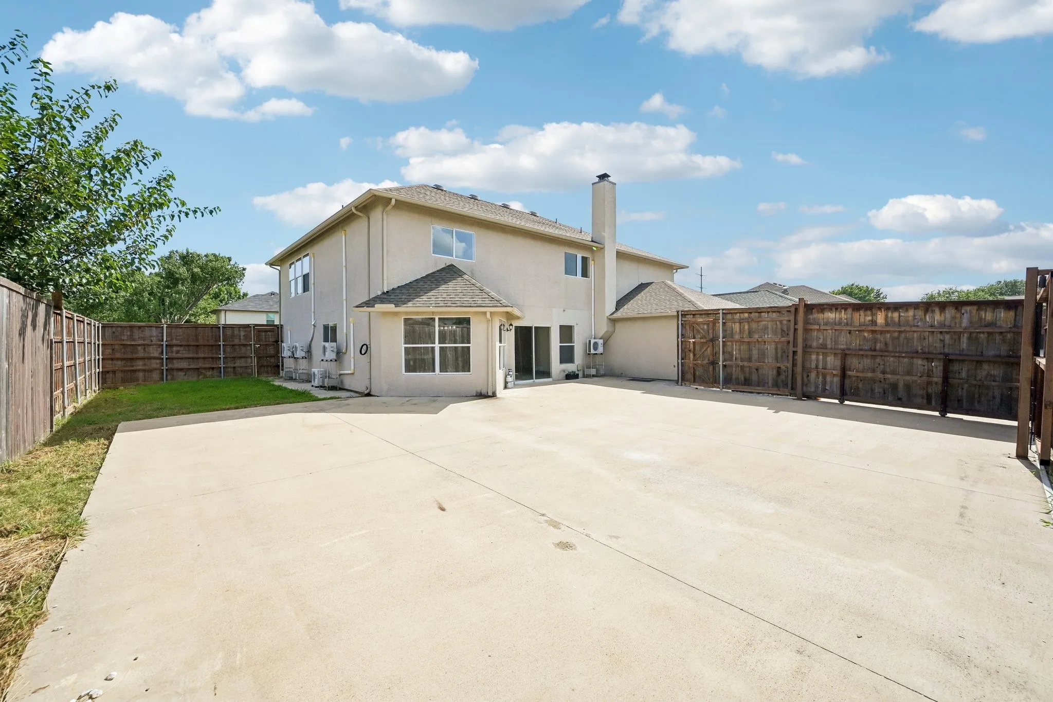 Expansive concrete patio area extending from the rear of the property