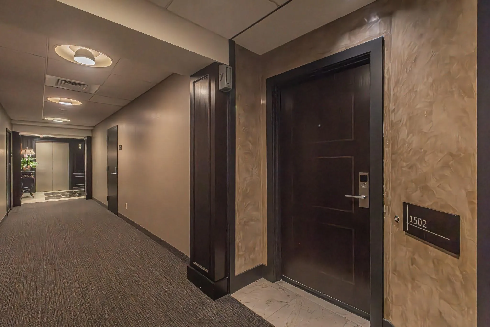 Apartment entry door 1502 featuring a dark wood-finish, modern handle, and secure lock system