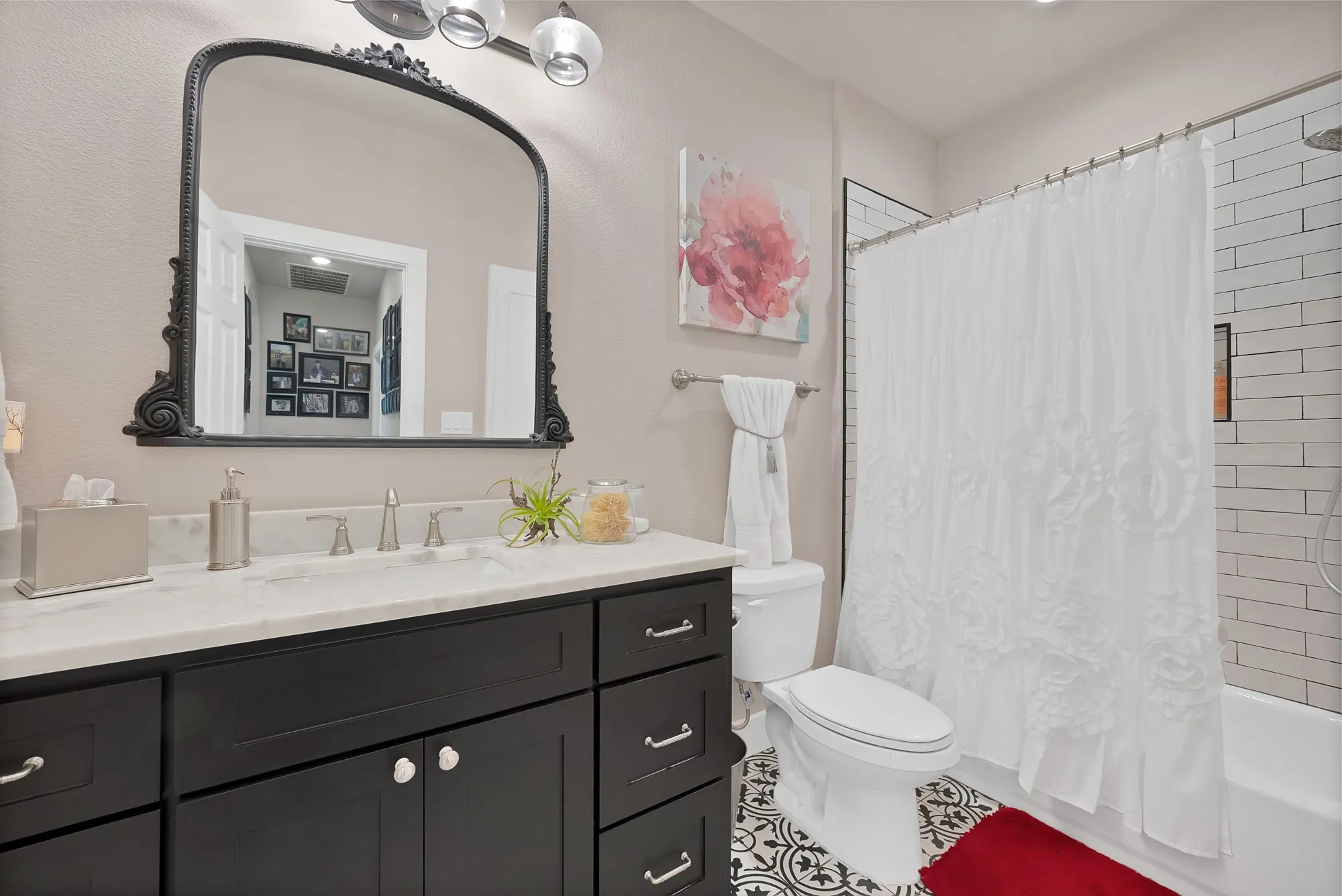 Bathroom featuring a dark wood vanity with a white countertop and dual-handle faucet