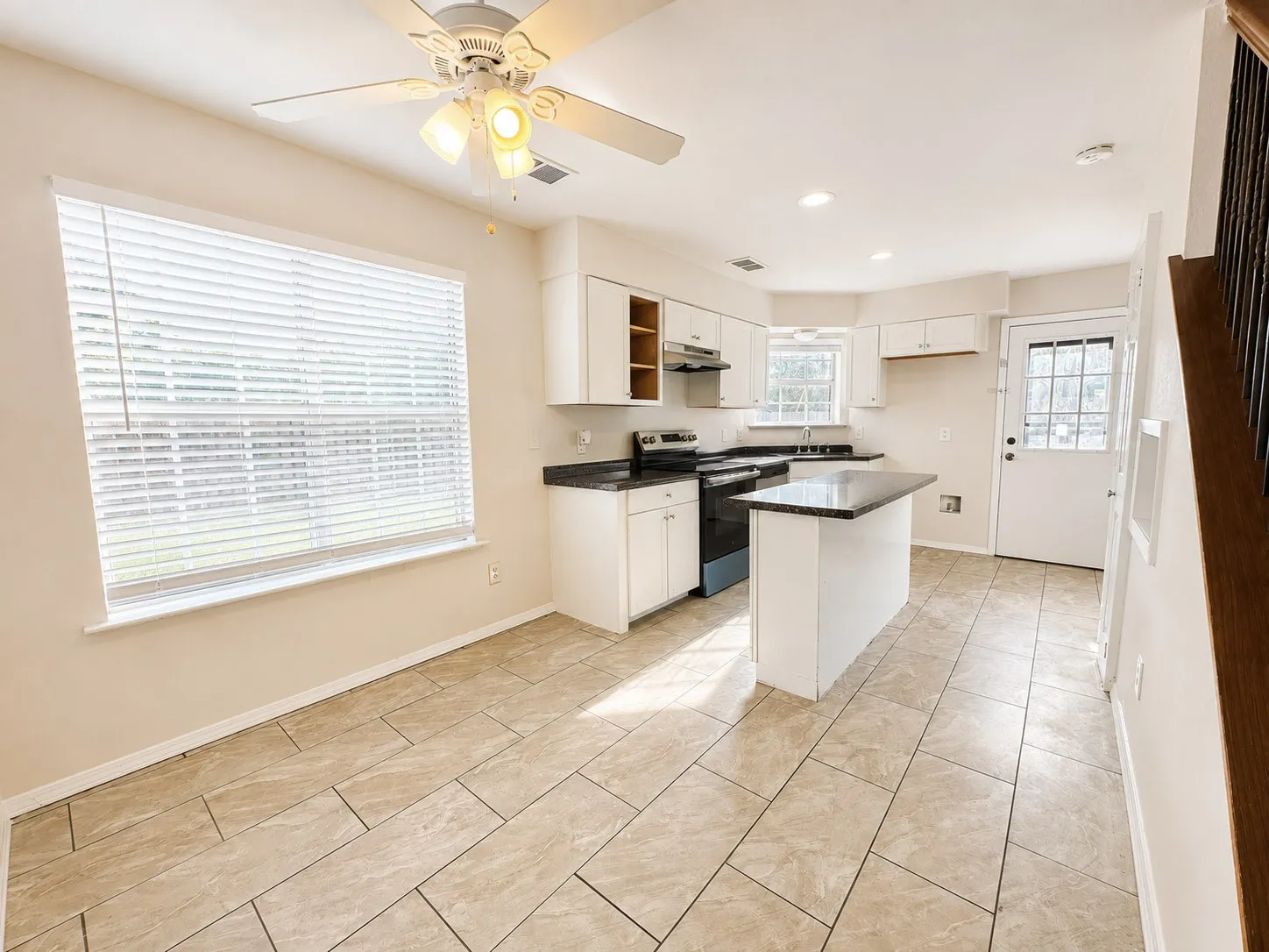 Open-concept kitchen and dining area featuring ceramic tile flooring