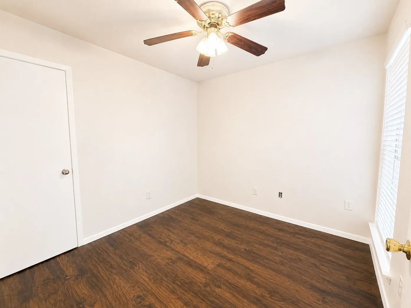 Neutral toned walls with dark wood-finish flooring