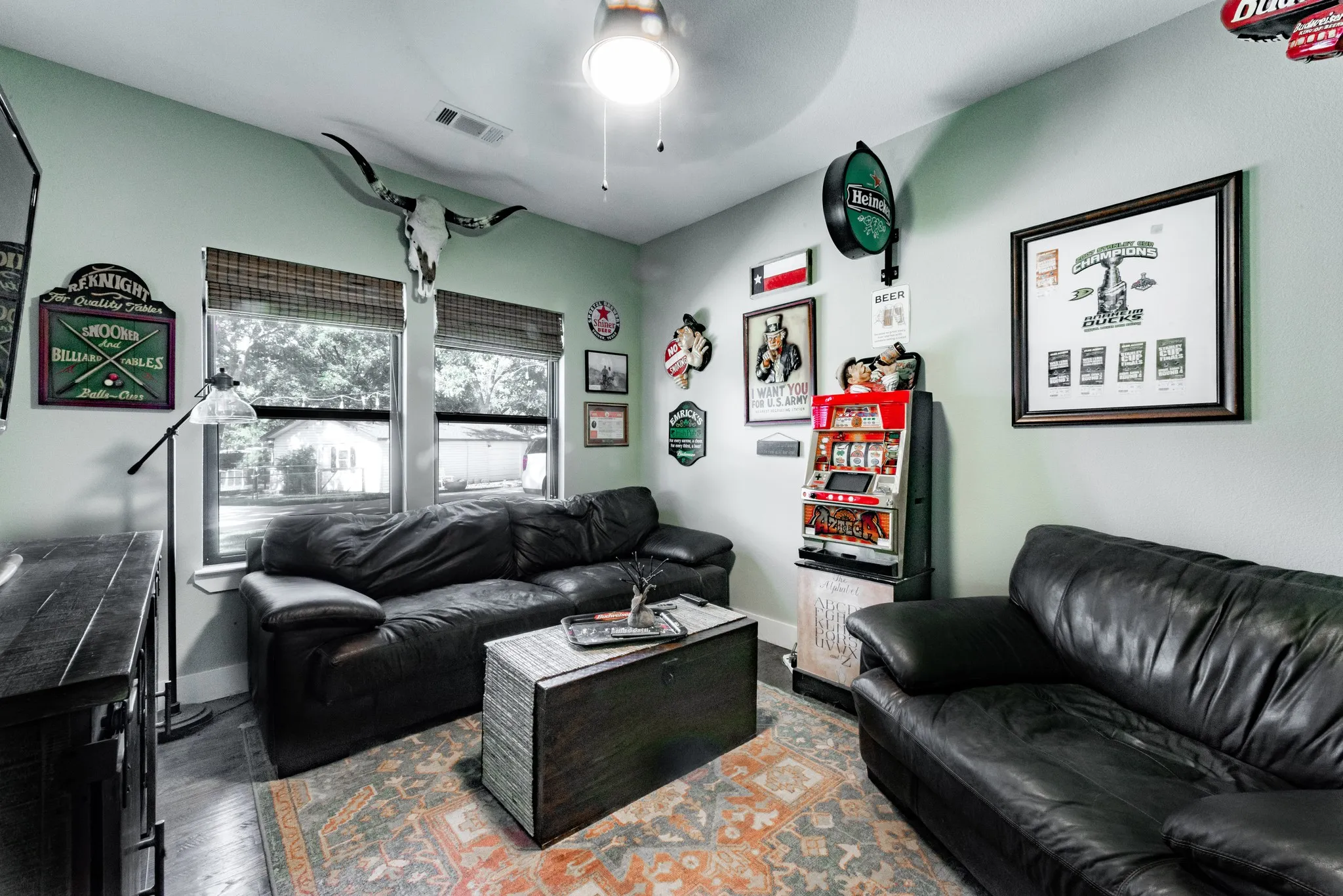Interior space featuring light gray walls, wood-finish flooring, and a ceiling fan with integrated lighting