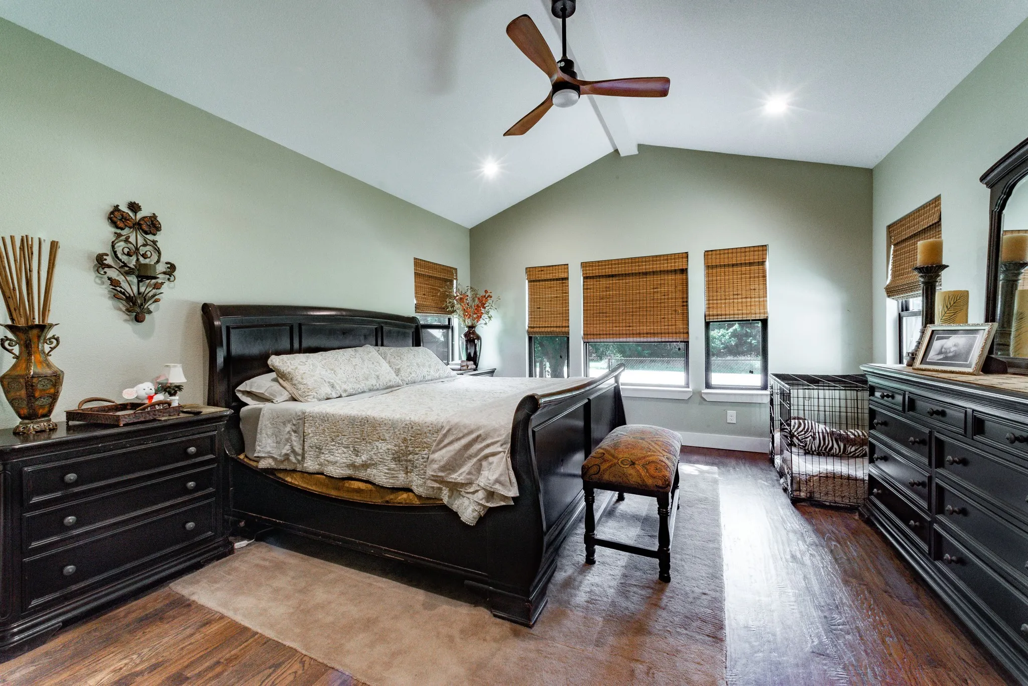 Spacious interior featuring a vaulted ceiling with an overhead fan, recessed lighting, and wood-finish flooring