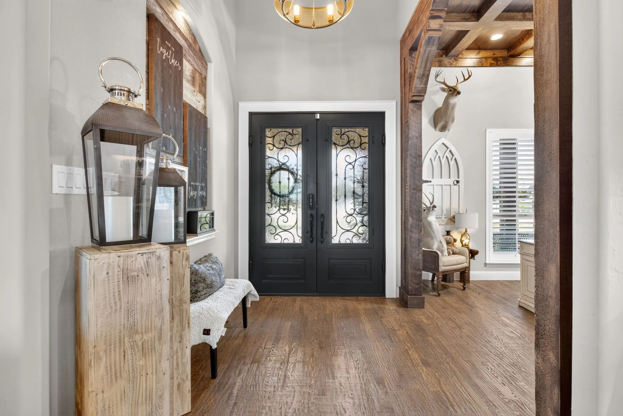 Double entry doors featuring decorative ironwork and frosted glass