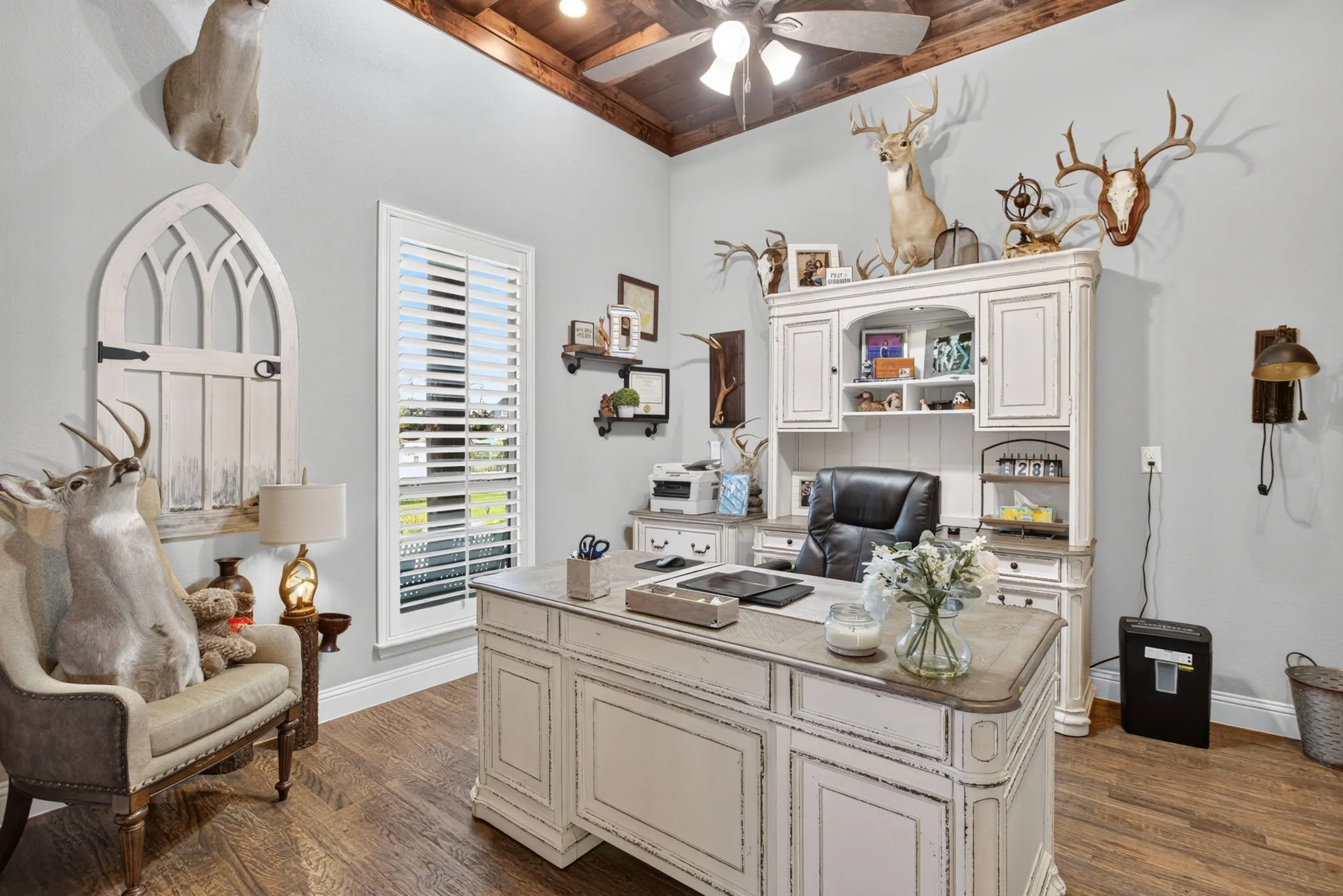 High ceilings with wood-finish planks, wood-finish flooring, and light-toned walls create a bright and open atmosphere