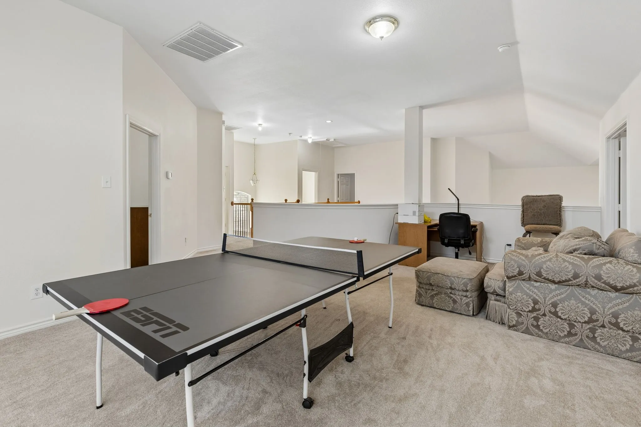Expansive bonus room featuring sloped ceilings, recessed lighting, and carpet flooring