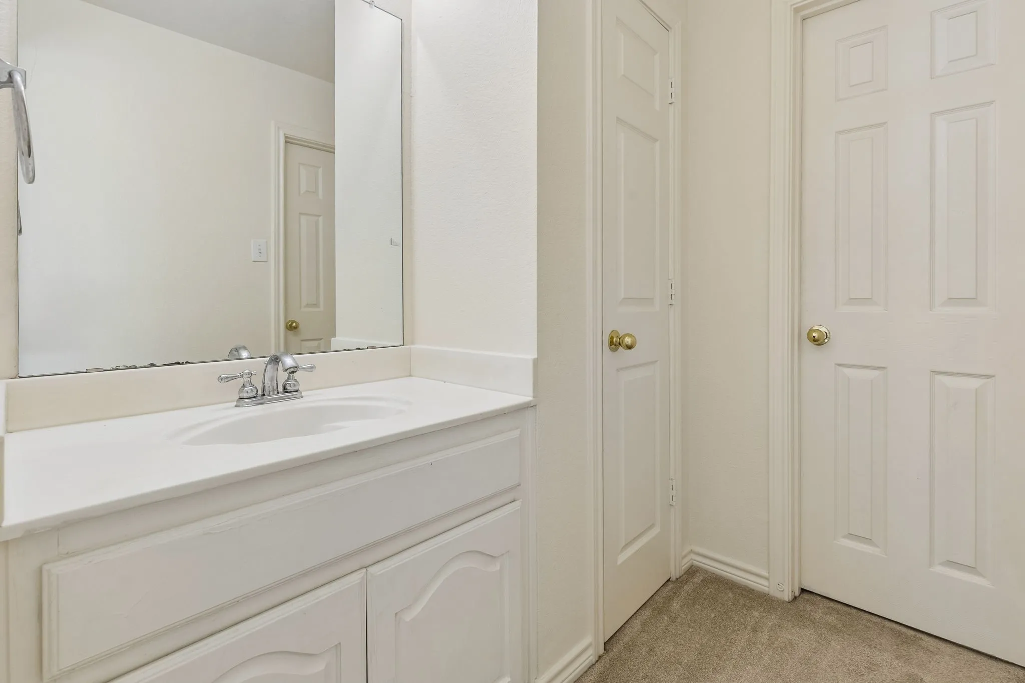 Bathroom vanity with an integrated sink and chrome faucet