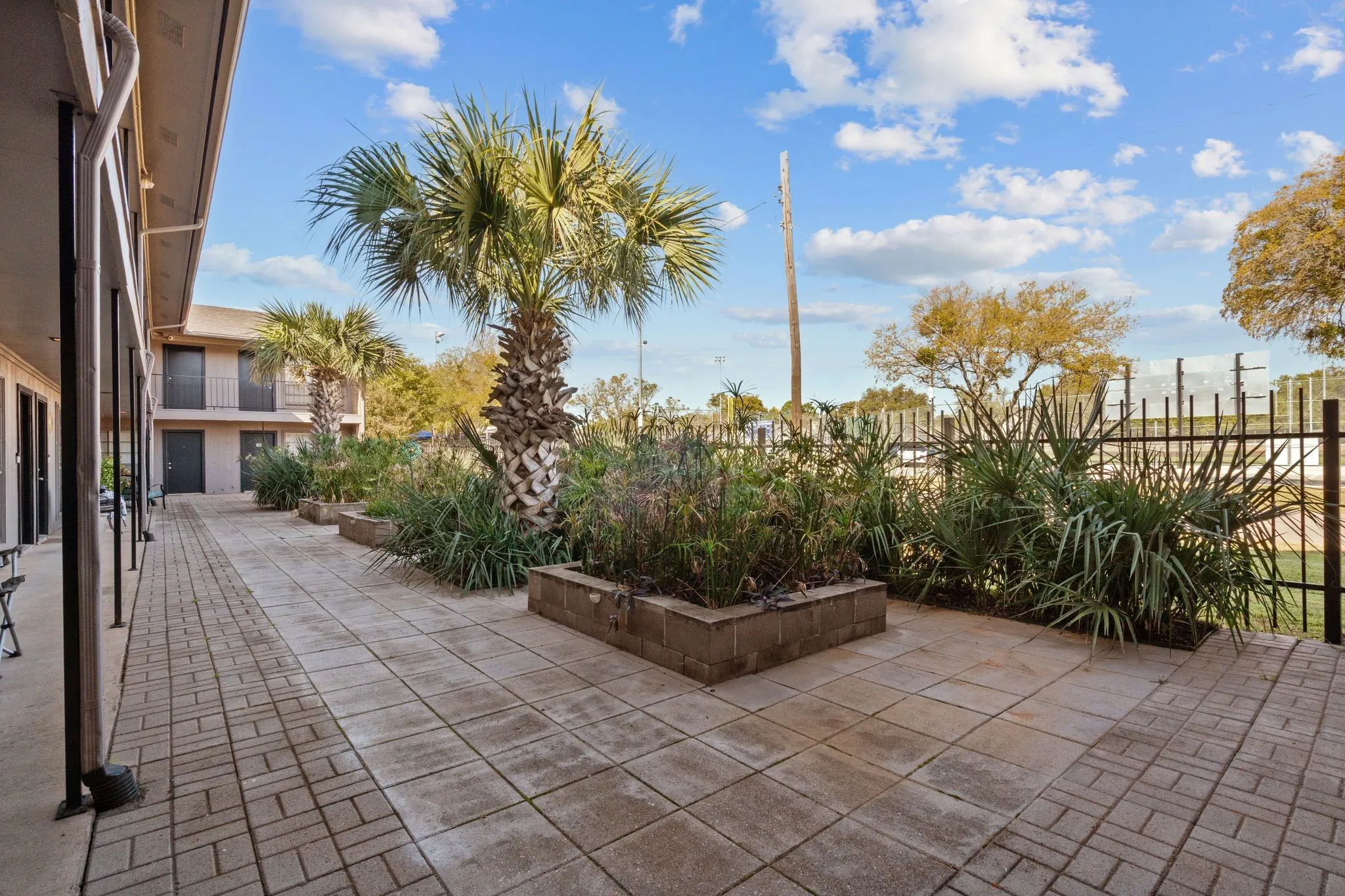 Paved walkway featuring a brick pattern border and square paver sections