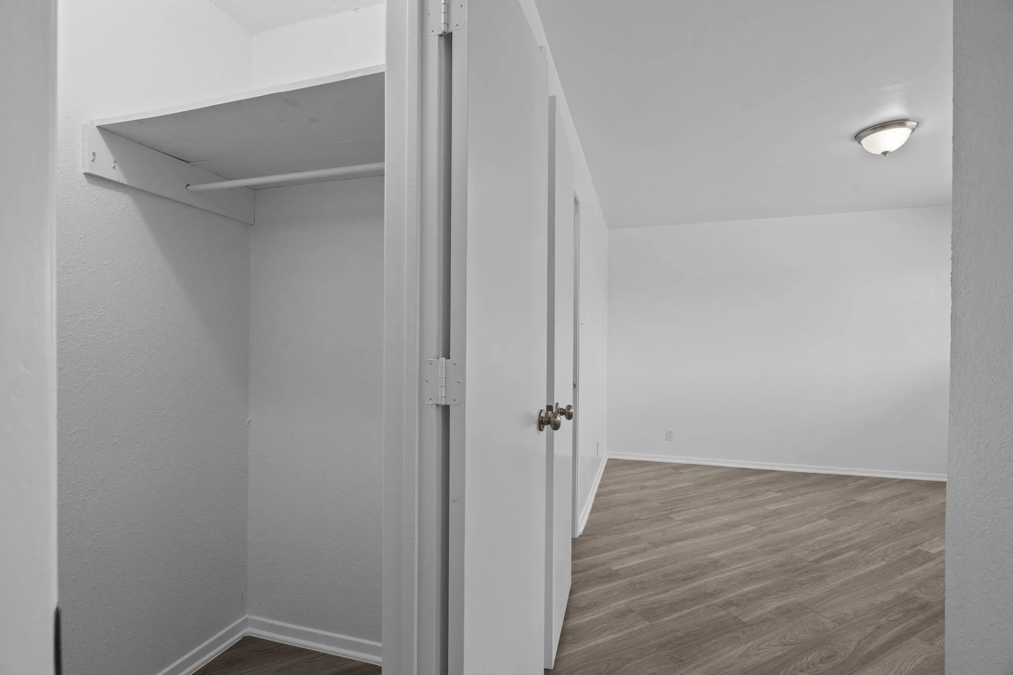 Open closet space featuring an integrated shelf and clothing rod