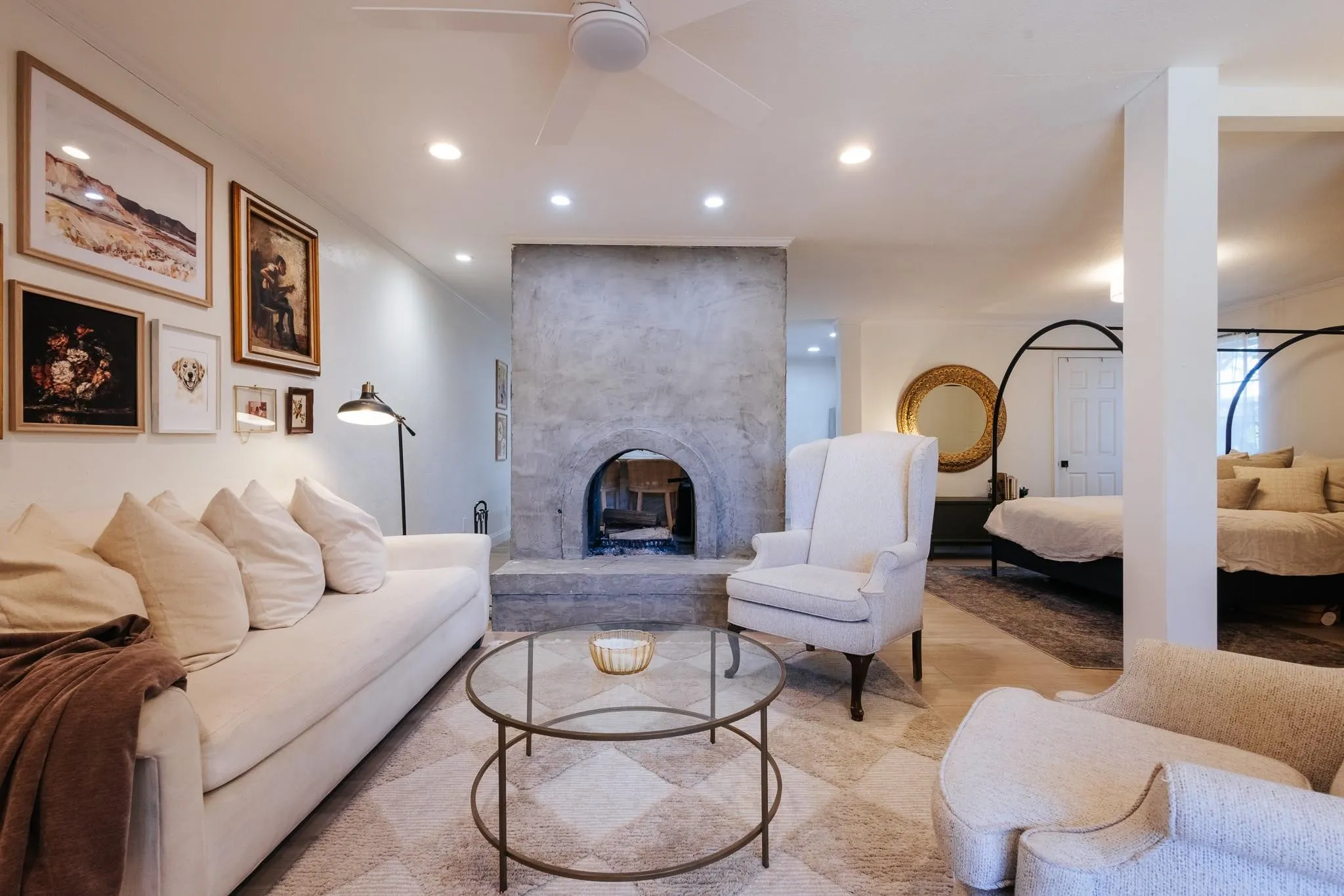 Living area featuring a concrete fireplace, recessed lighting, ceiling fan, and light-toned flooring
