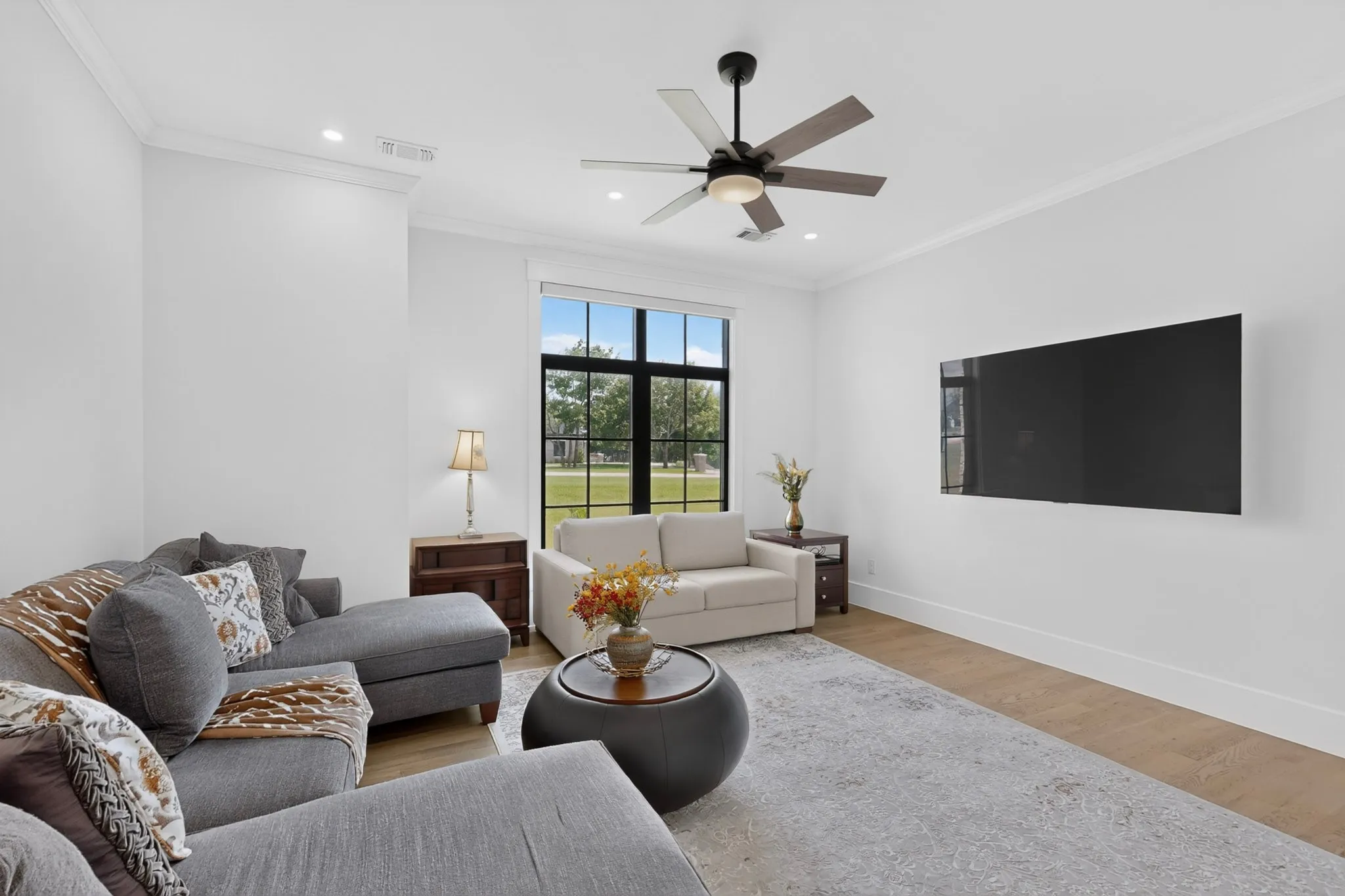 Swing room, which could easily sub as Bedroom 4, is currently used as a Home Entertainment Room, with light wood-finish flooring and a large area rug