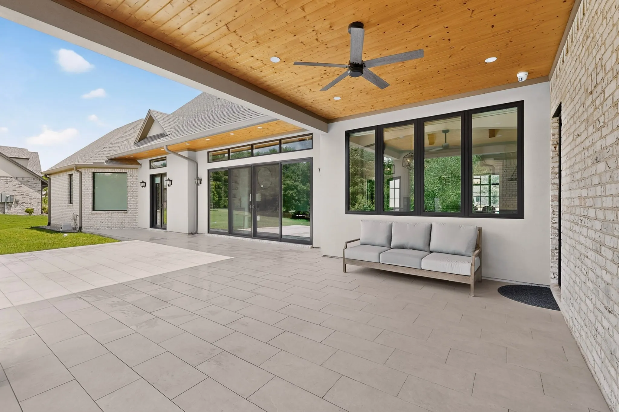 Covered patio featuring a wood-paneled ceiling with recessed lighting and a ceiling fan
