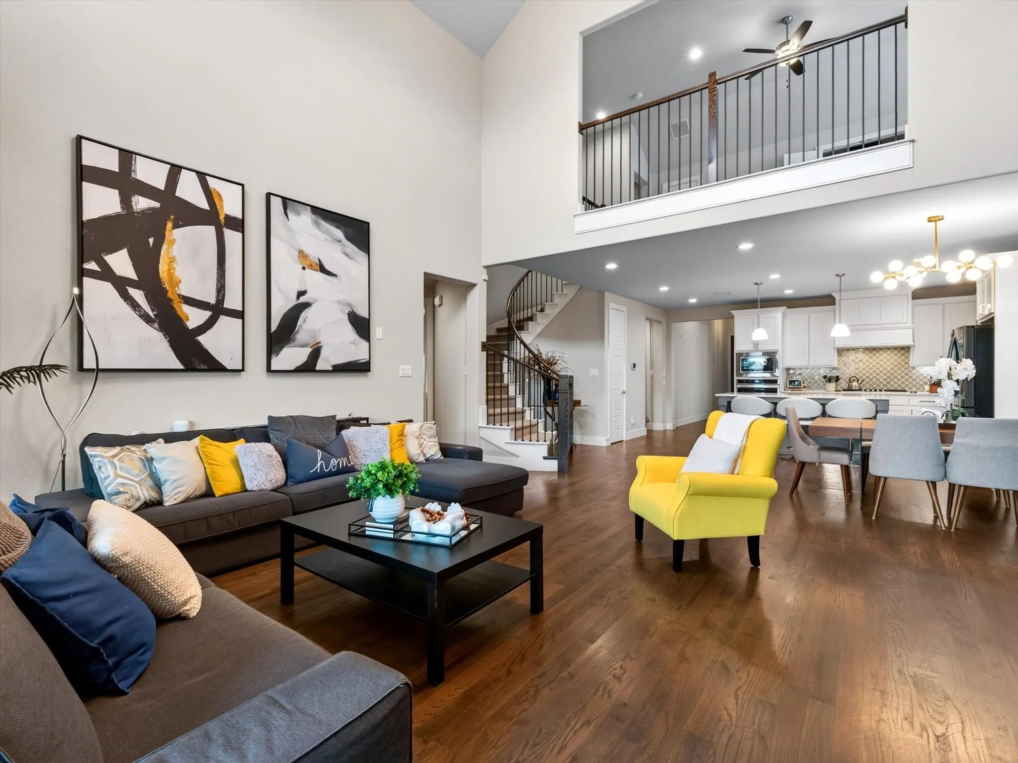 Open-concept living space with high ceilings and wood-finish flooring