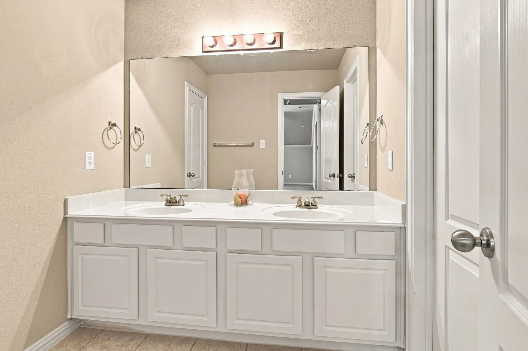 Dual vanity with white cabinetry, white countertop, and integrated sinks
