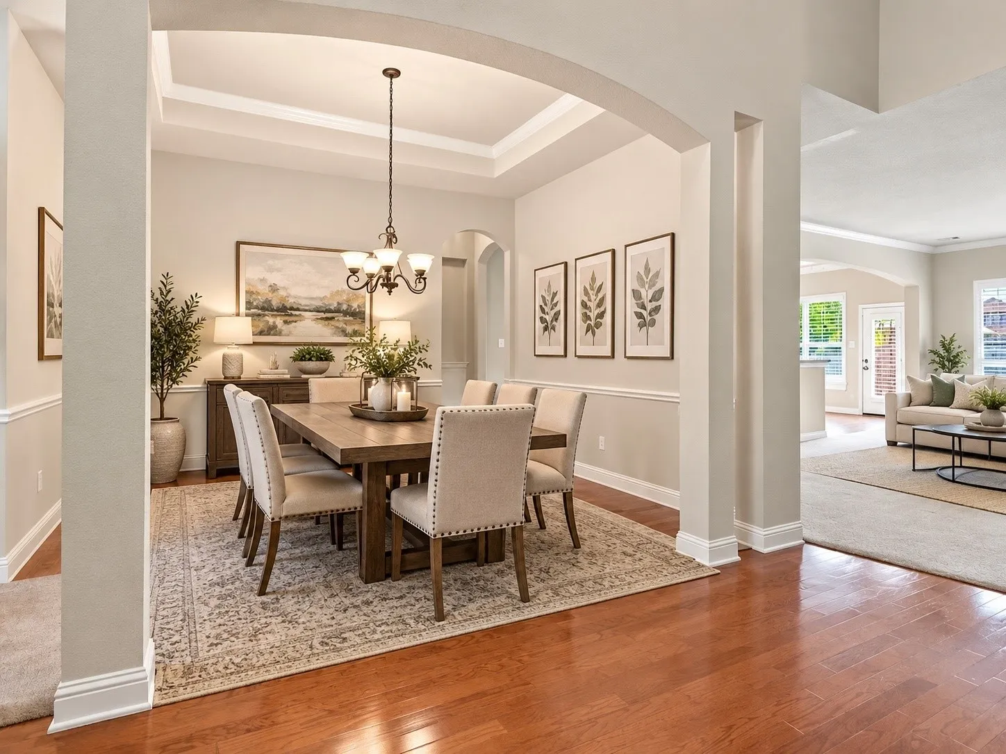 AI Generated Tray ceiling with crown molding, archway entry, chair rail molding, wood-finish flooring, and a chandelier lighting fixture