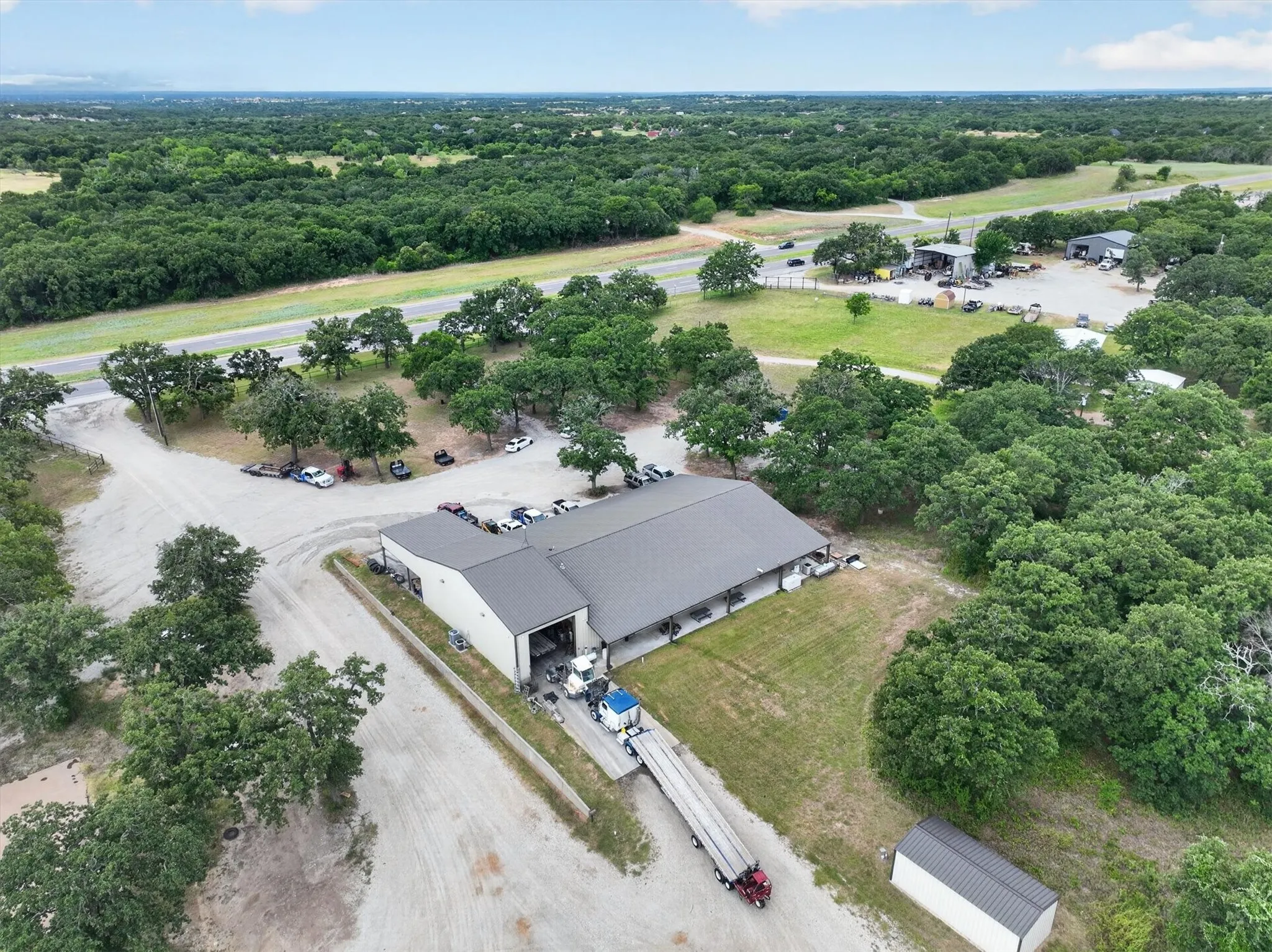 Expansive commercial property featuring a large warehouse building with a dark gray roof