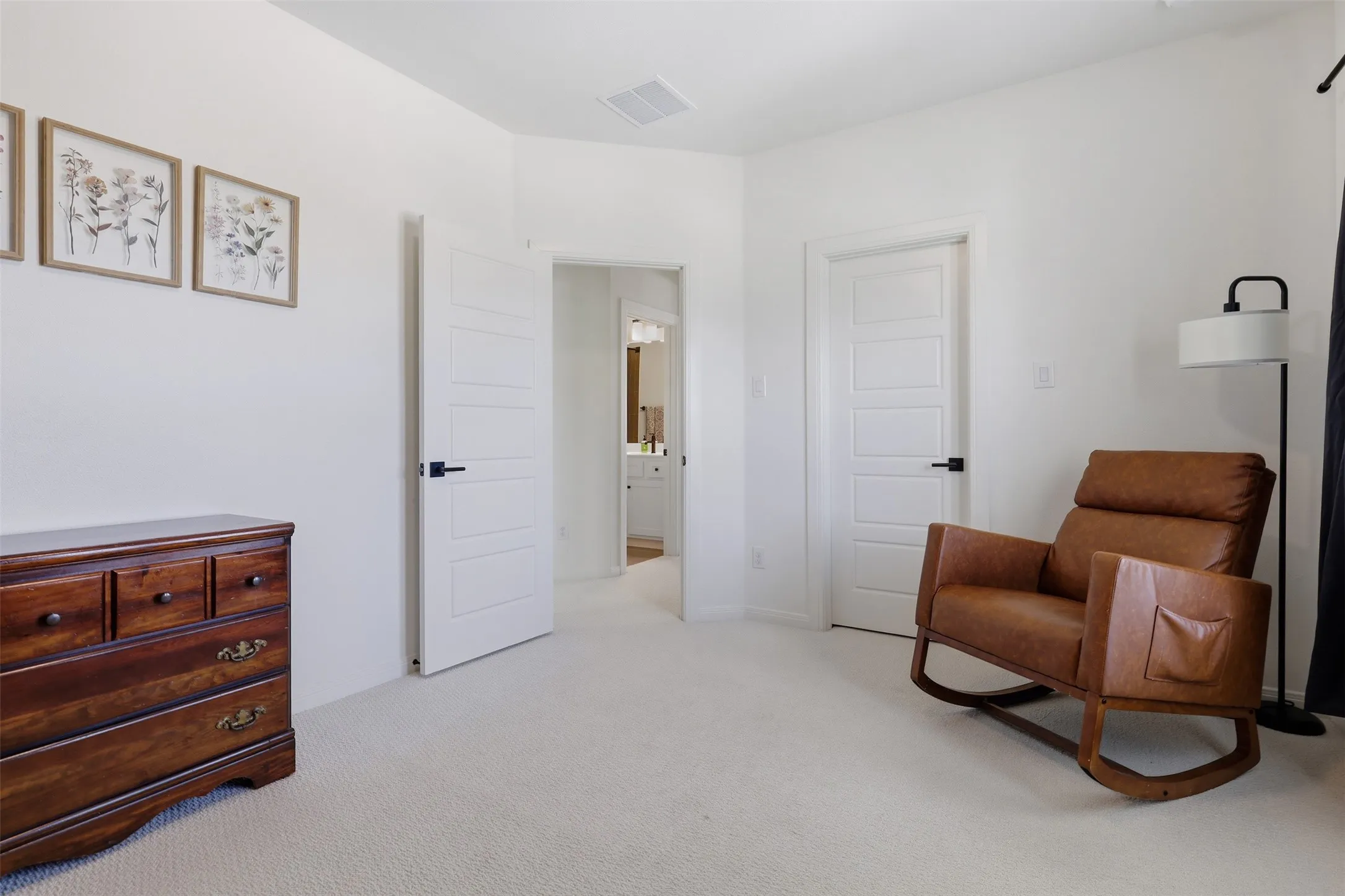 Bright room featuring plush carpet flooring and white walls