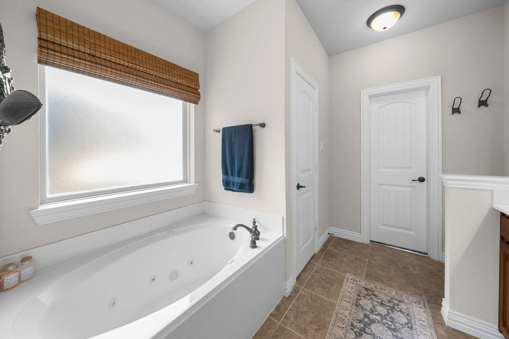 Primary bath features a jetted garden tub and lots of natural light.