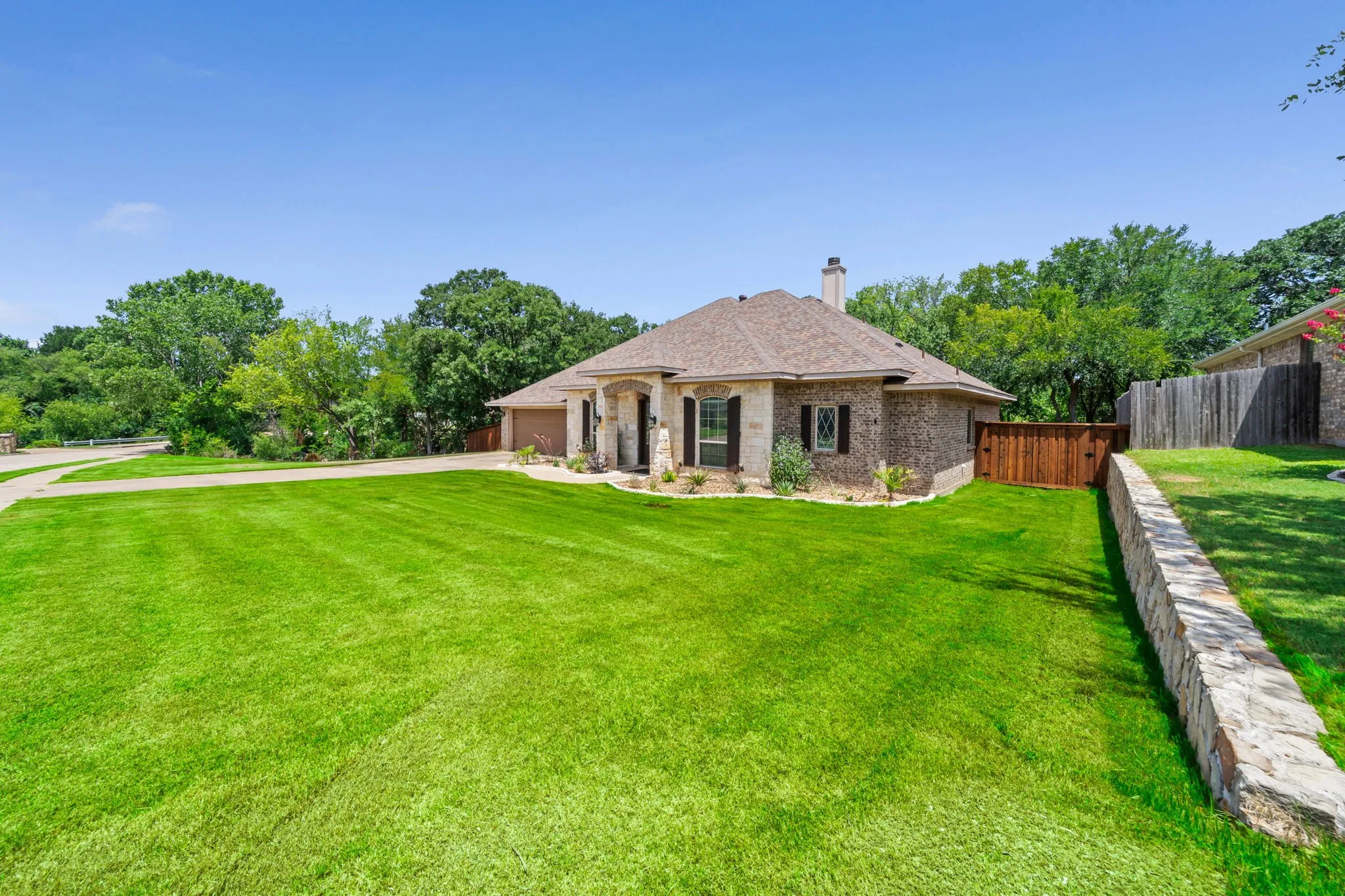 Beautiful stone and brick front elevation with low maintenance landscaping.