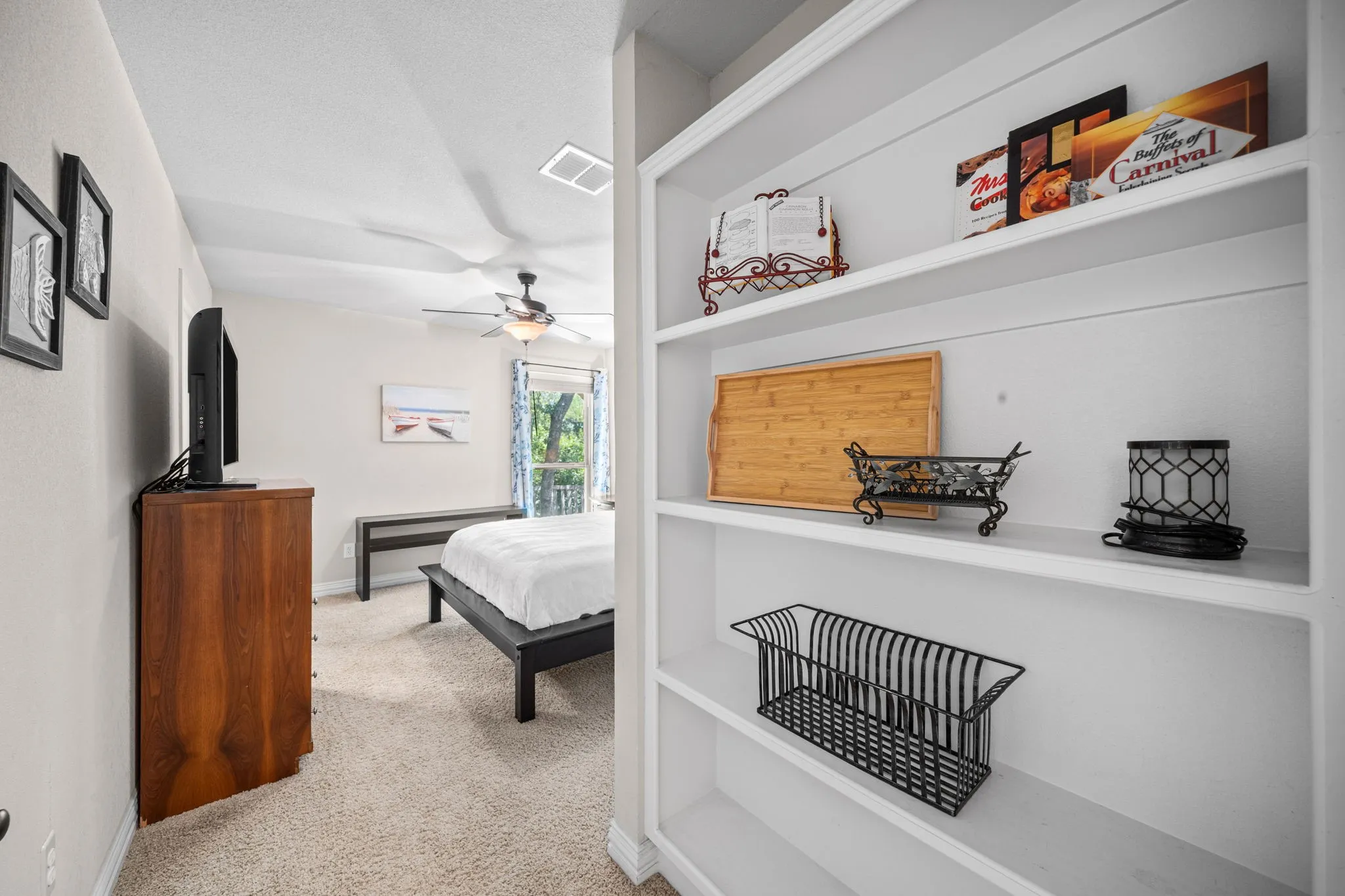 Secondary bedroom with neutral colors and built-ins.