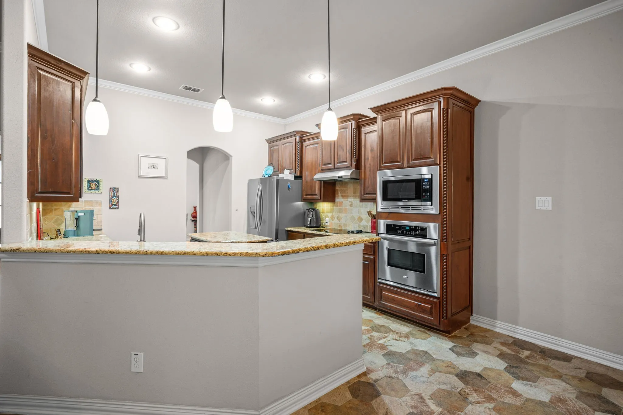 Kitchen features beautiful wood cabinets with an abundance of storage.