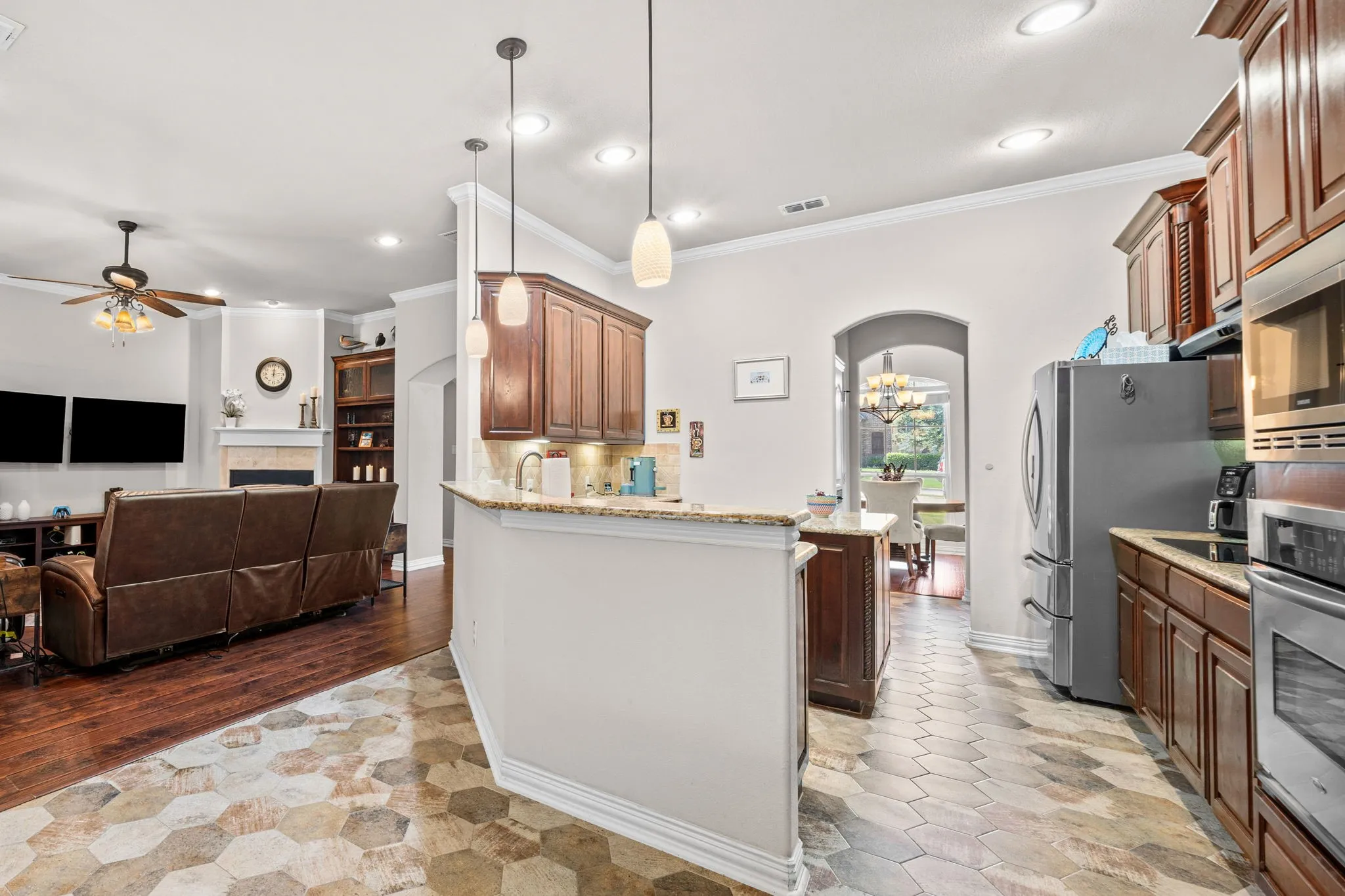 Kitchen features a granite wrap-around breakfast bar.