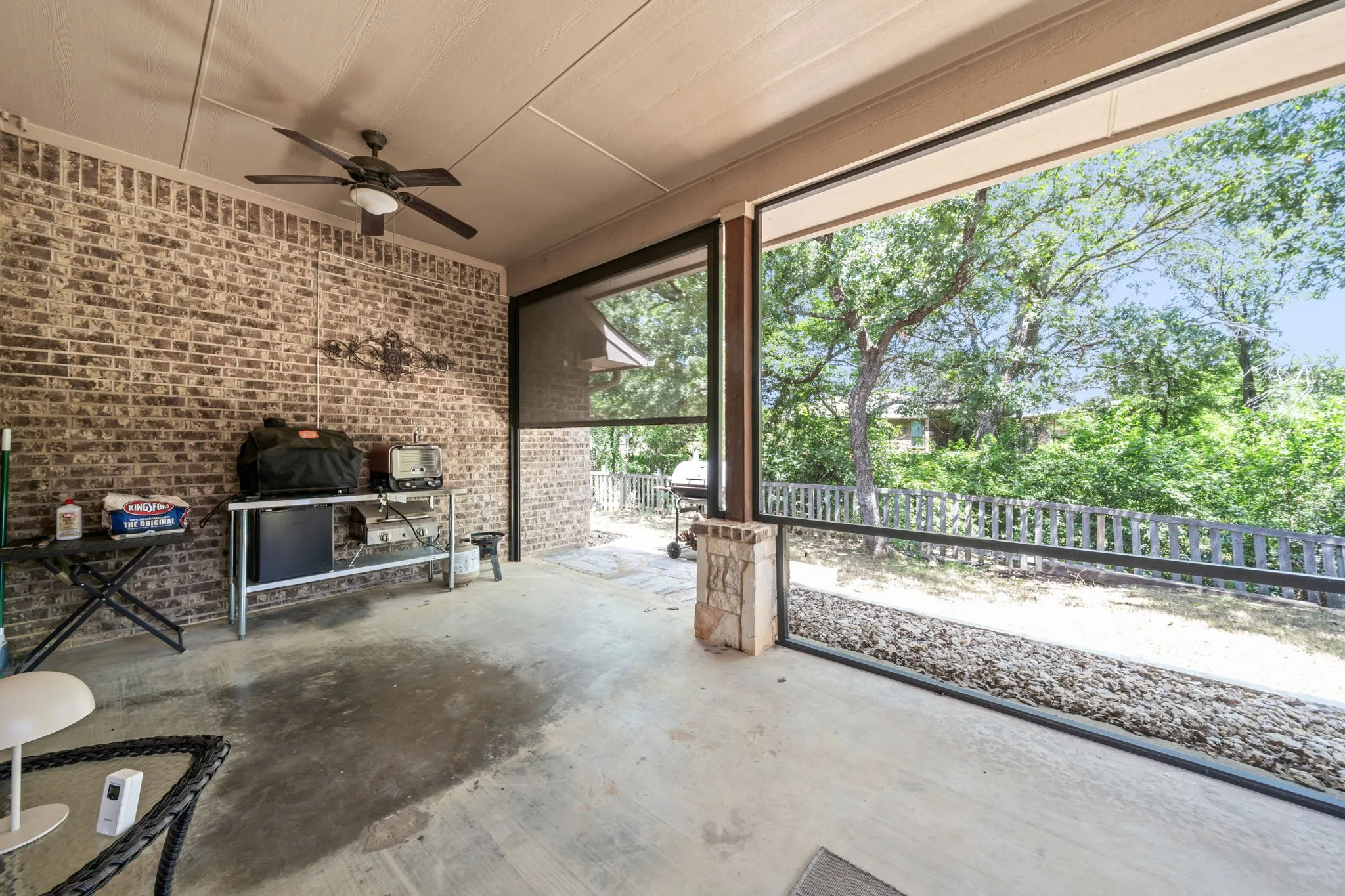 Enclosed patio features an electric retractable screen.