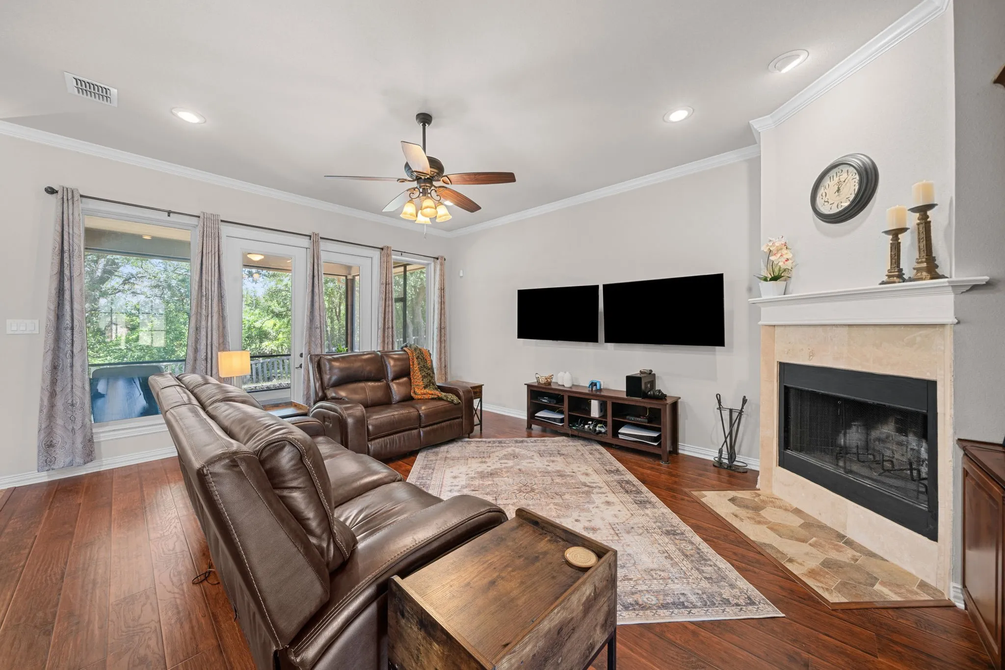 Spacious living area with  engineered wood floors and a beautiful fireplace.