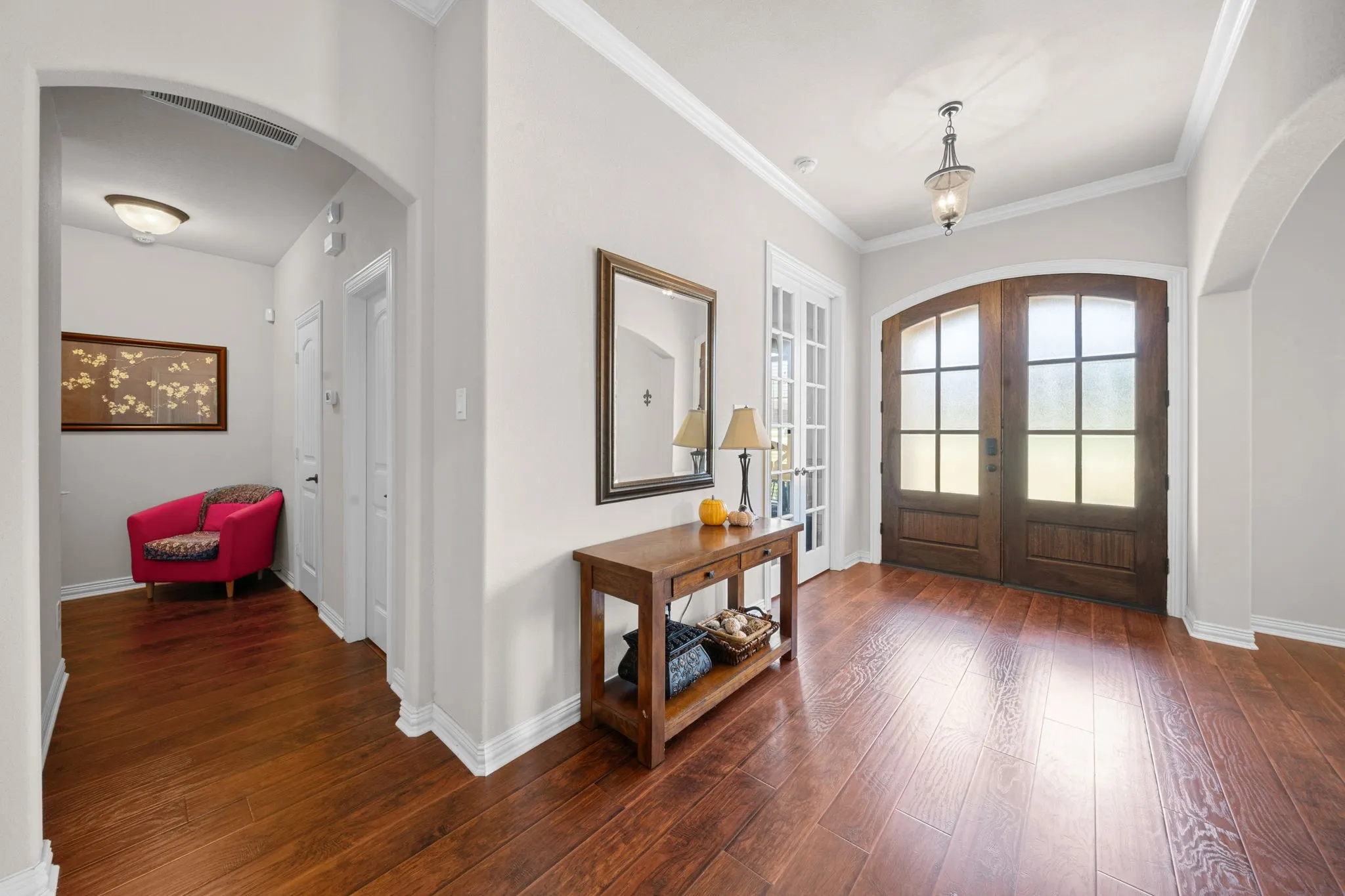 Grand Foyer with a beautiful double door and engineered wood floors.