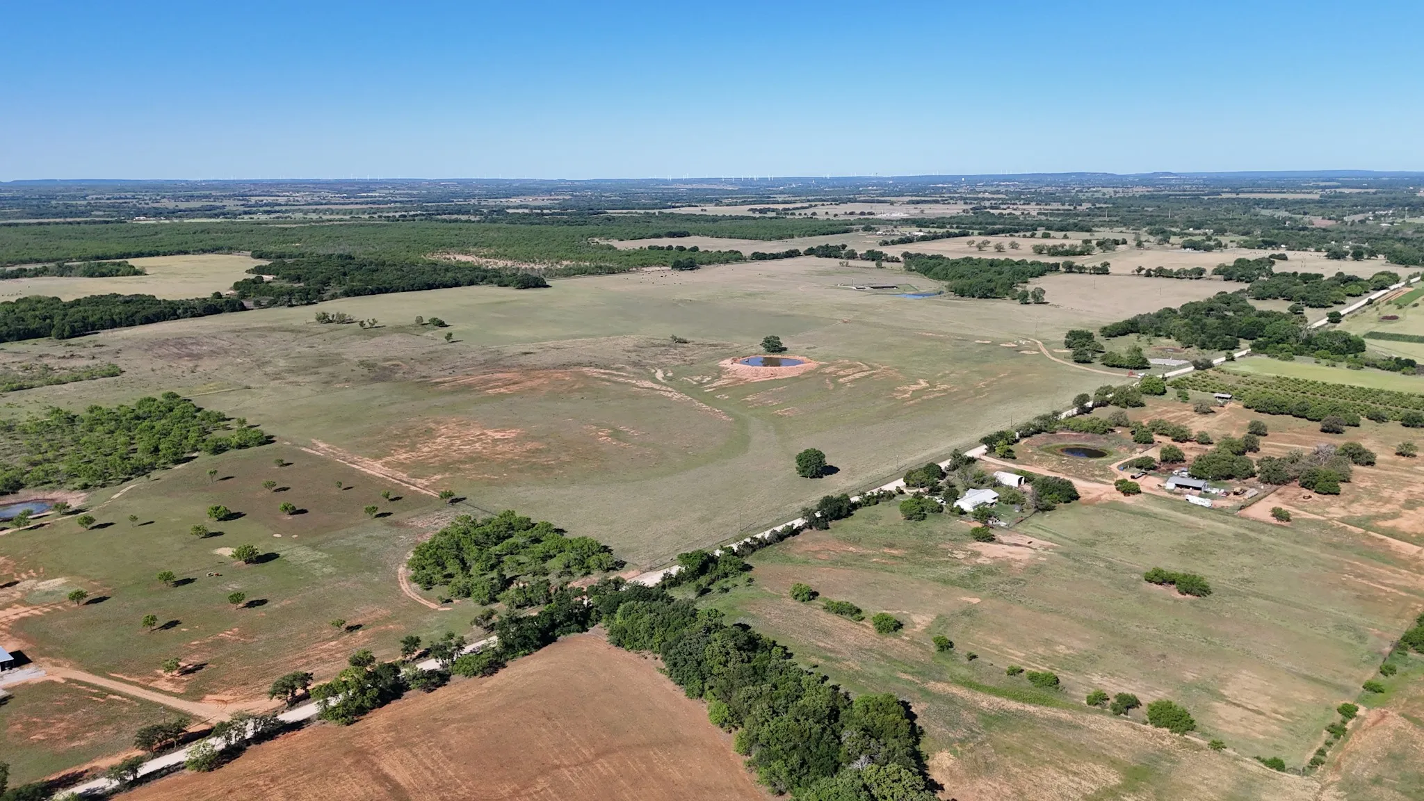 Expansive acreage featuring a mix of open fields and wooded areas