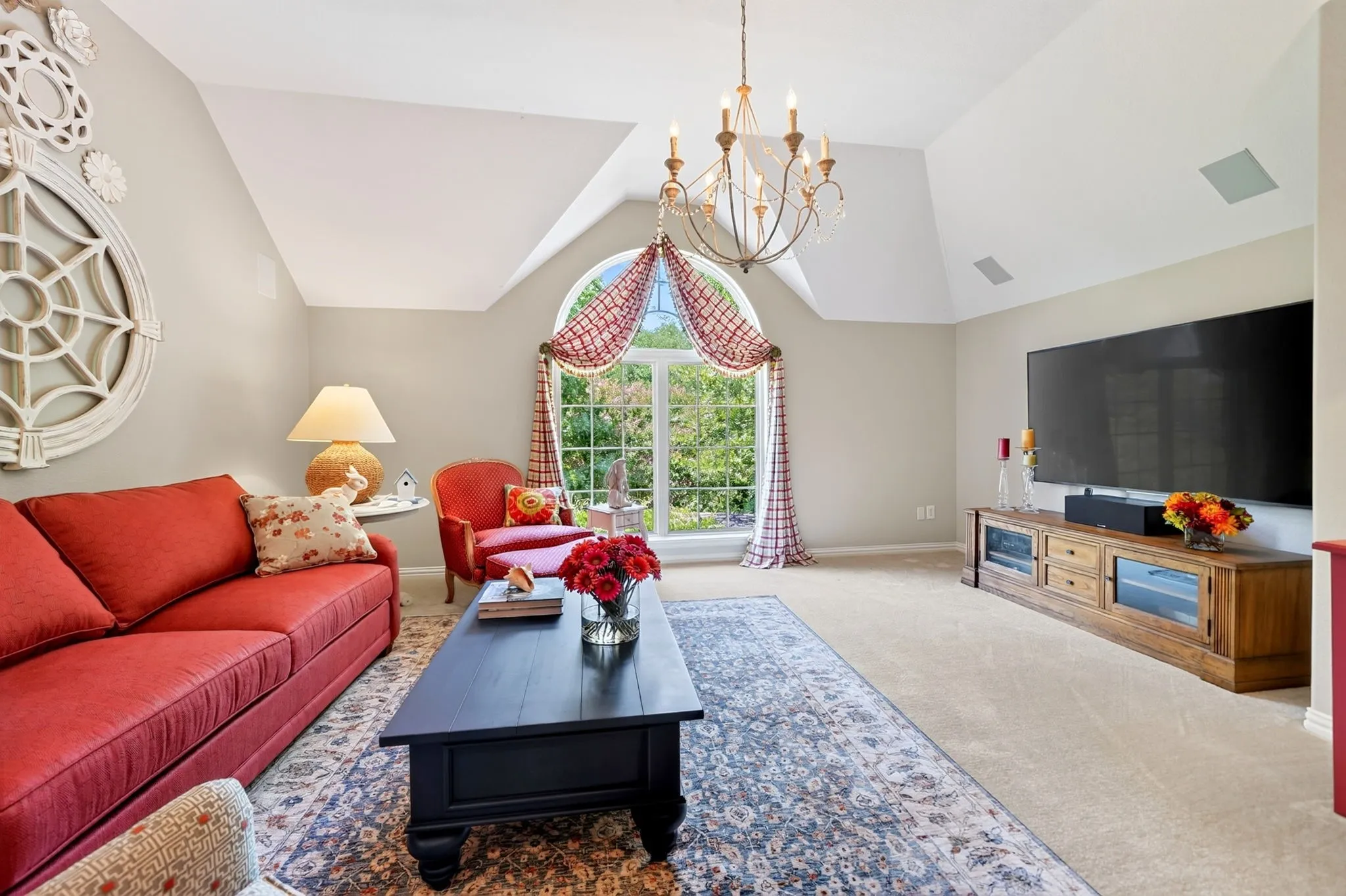 Vaulted ceiling featuring a decorative chandelier and recessed ceiling speakers