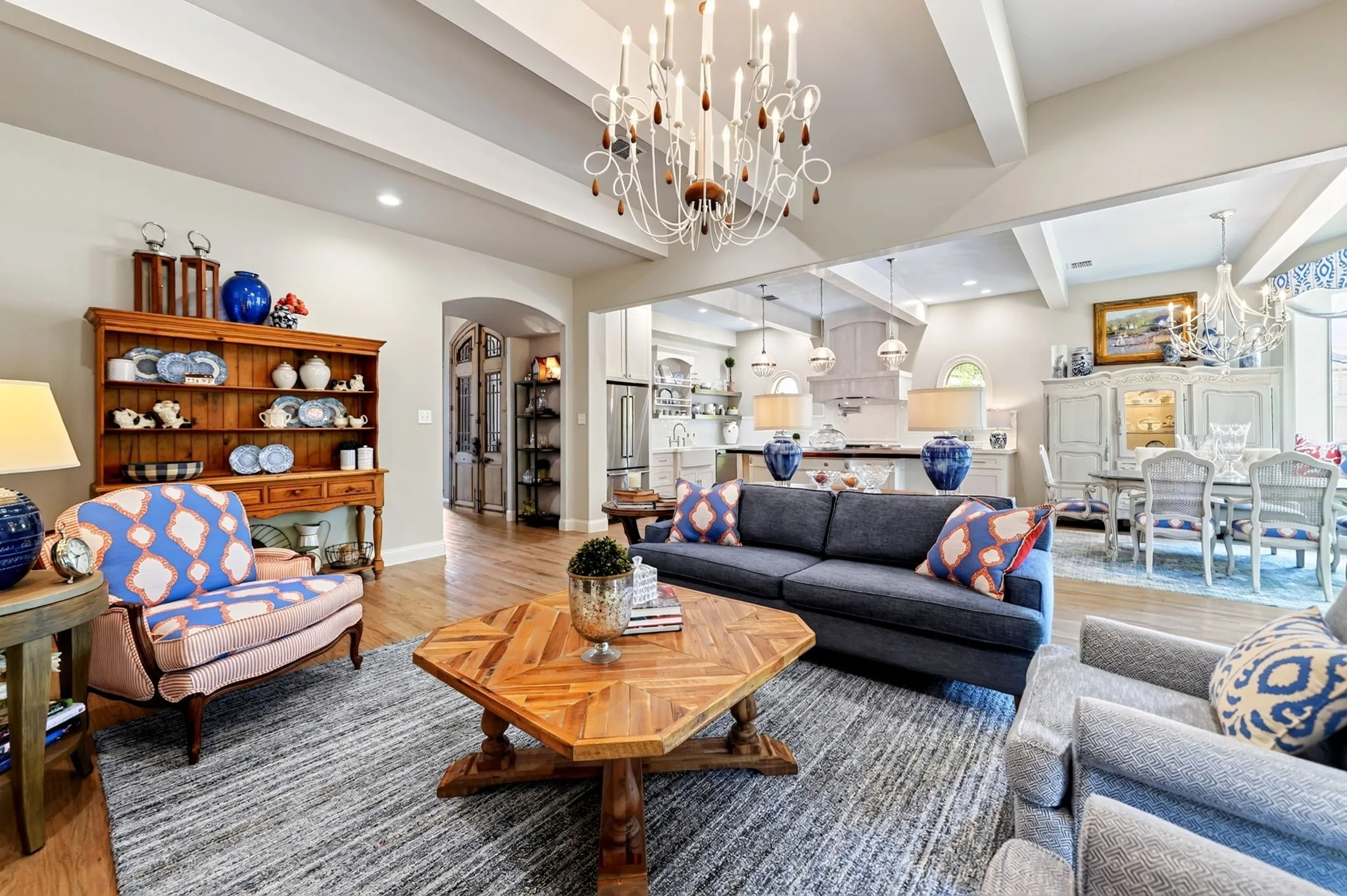 Spacious living area featuring exposed beam ceilings and wood-finish flooring