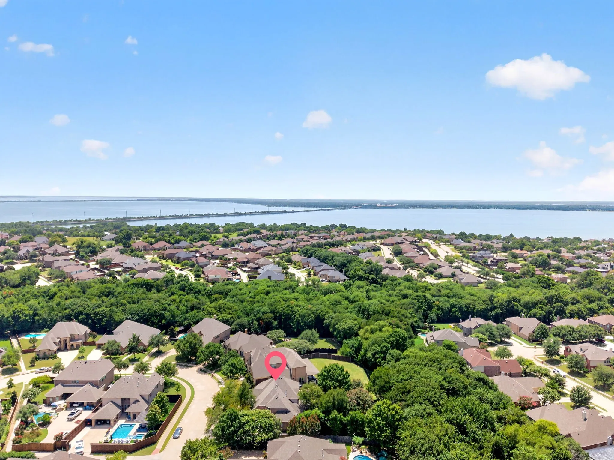 Aerial perspective showcasing a residential area with a prominent body of water in the background