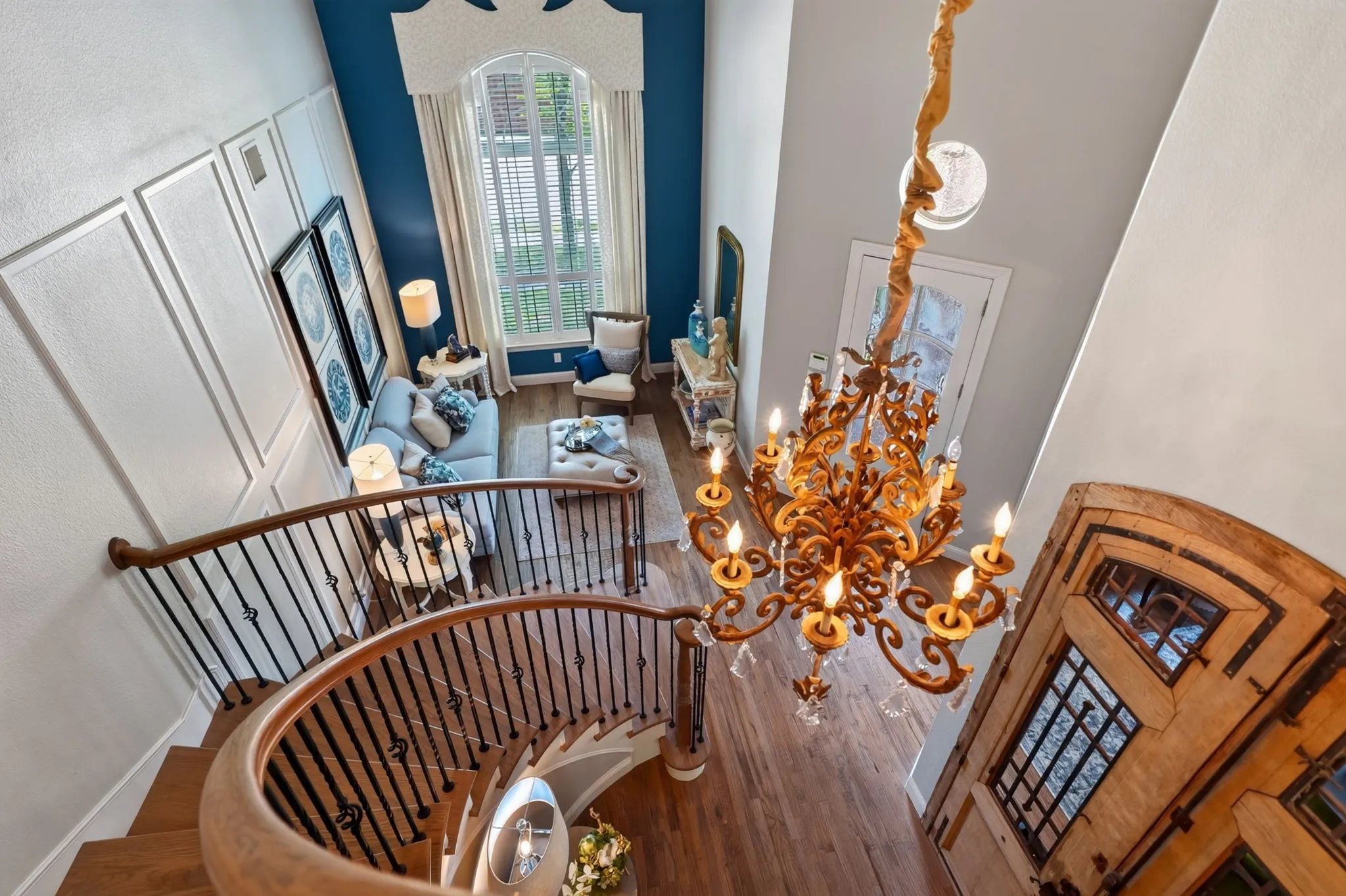 Grand foyer featuring a spiral staircase with wood-finish handrails and wrought iron balusters