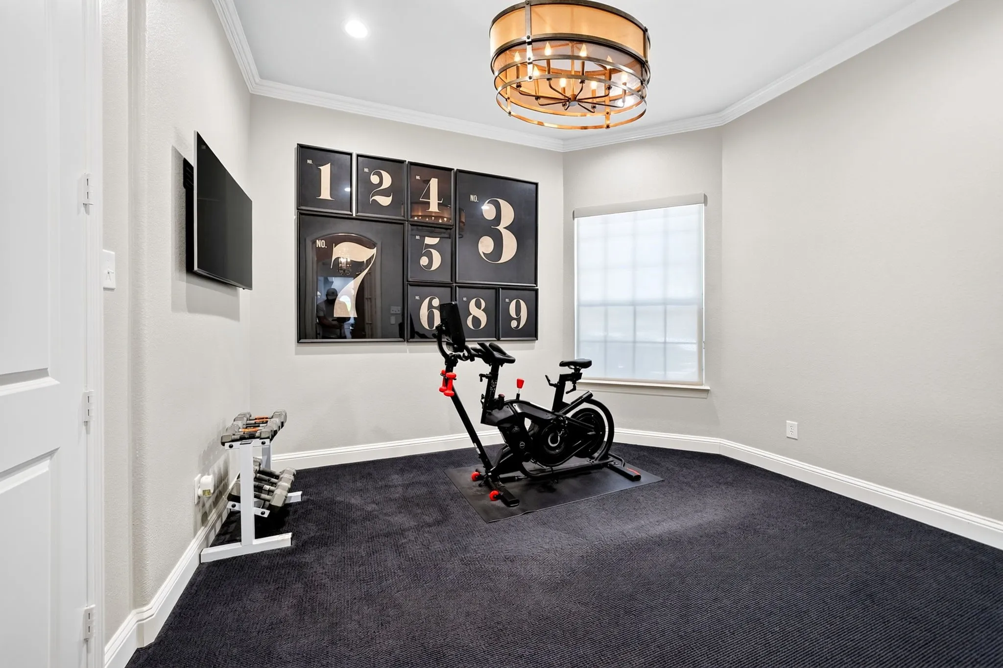 Dedicated room featuring dark textured carpeting, a single window with blinds, recessed lighting, crown molding, and a drum chandelier