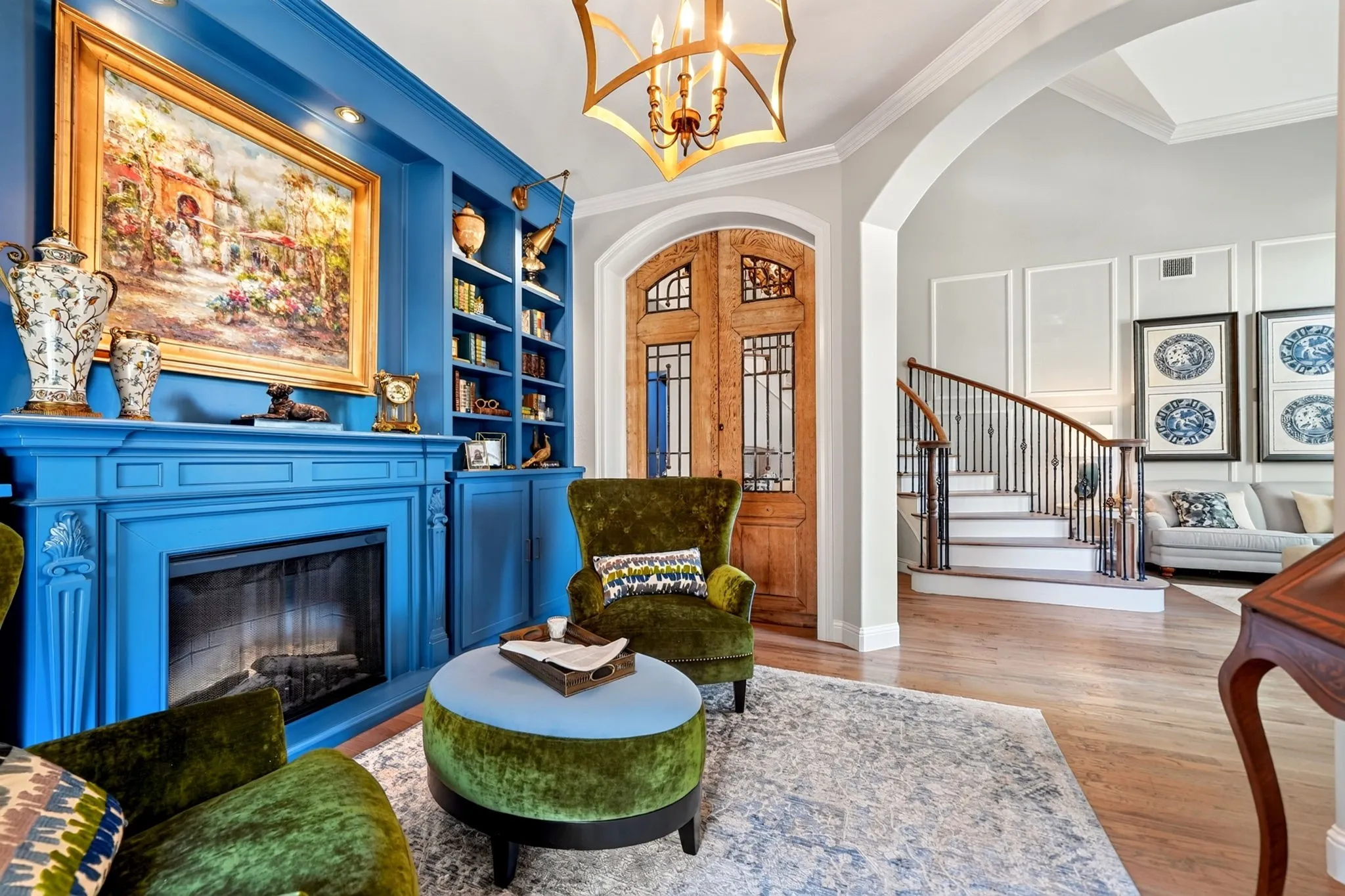 Vibrant blue built-in cabinetry with integrated fireplace and display shelving