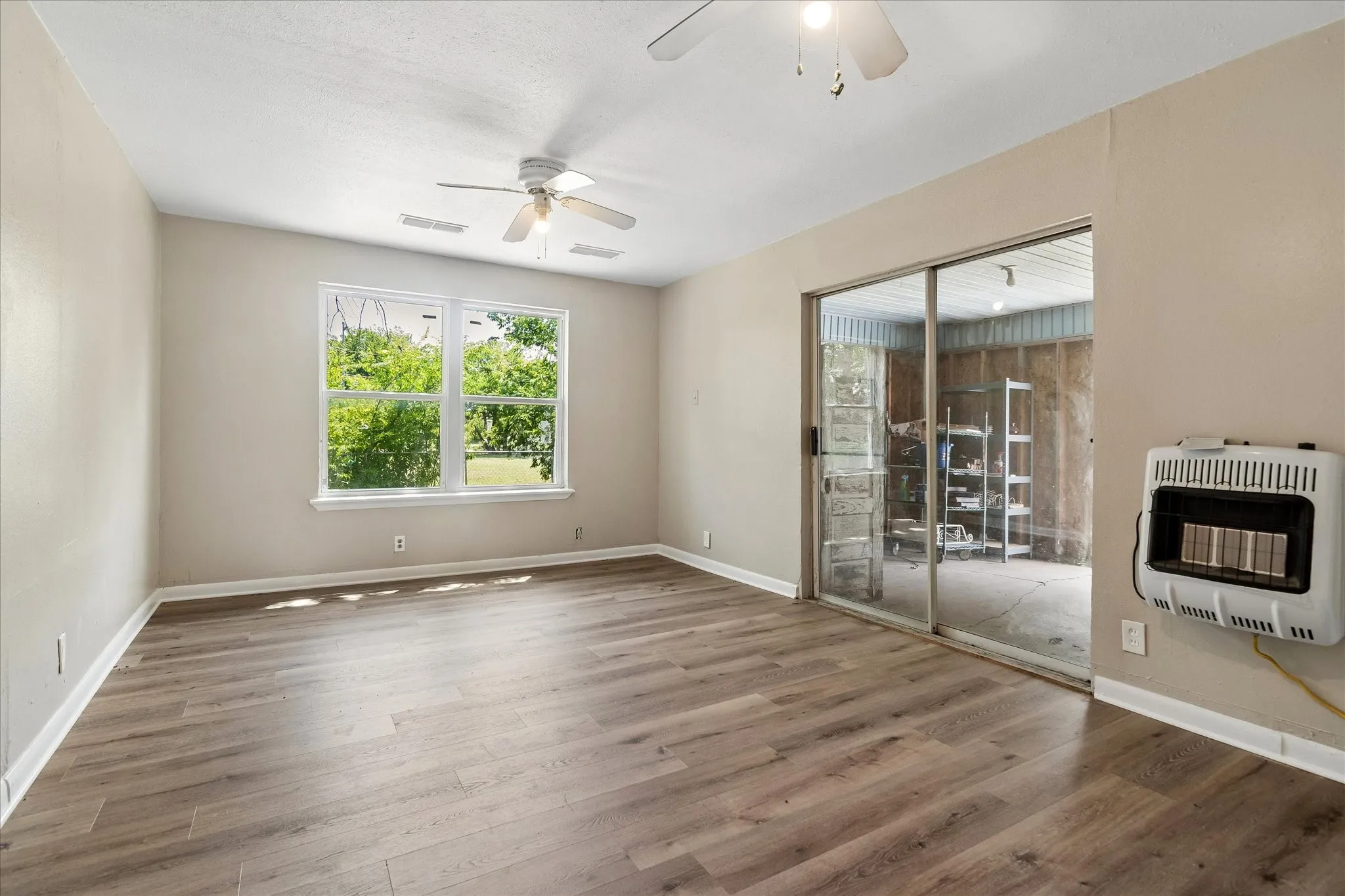 Primary bedroom with direct access to enclosed patio