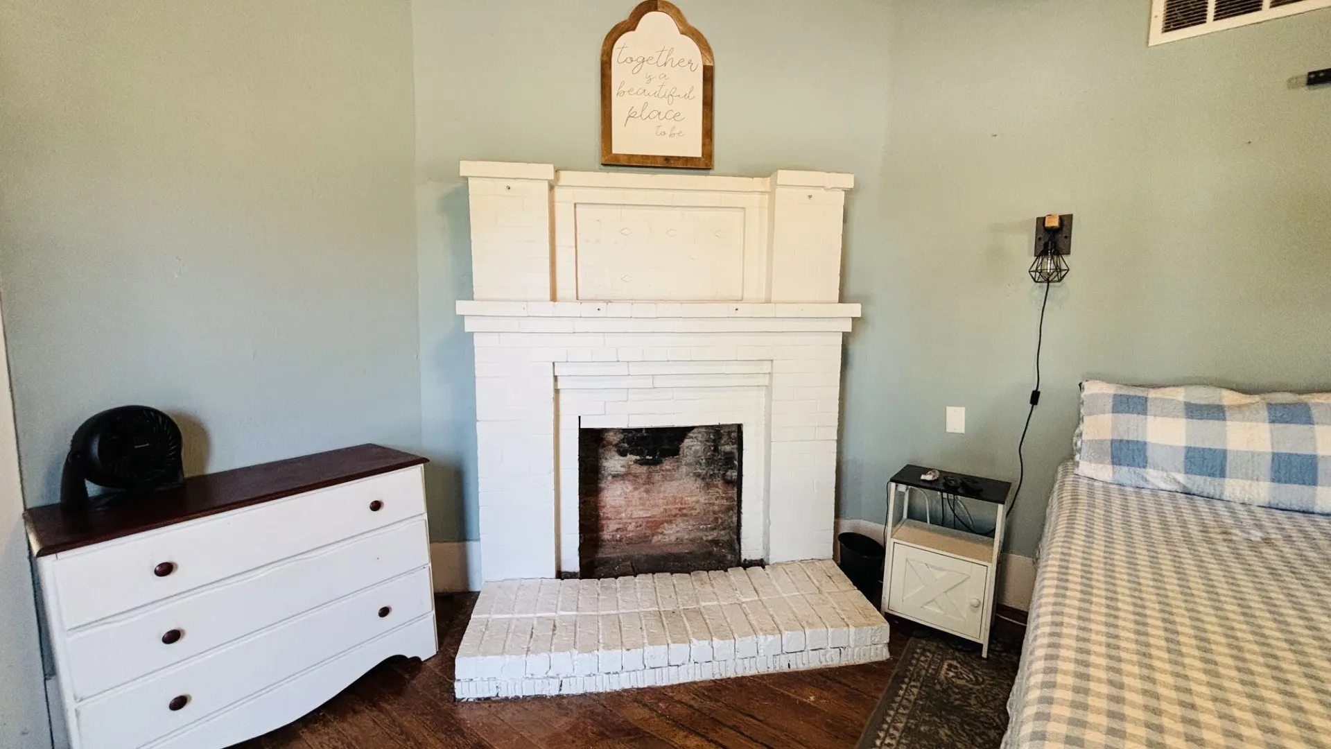 Decorative brick fireplace in primary bedroom.