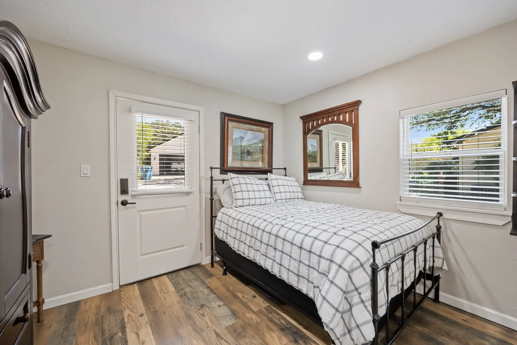 Wood-finish flooring, recessed lighting, and a window with horizontal blinds